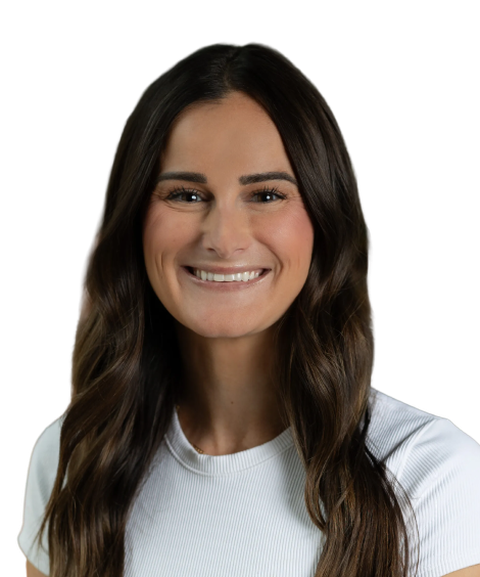 Smiling woman with long brown hair wearing a white shirt, facing forward against a plain white background.