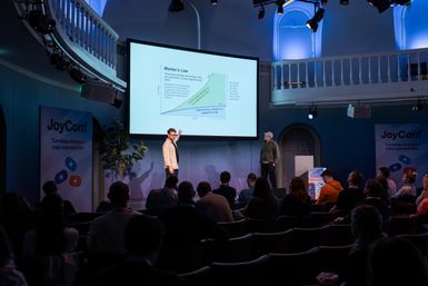 Customer Ellis Brigham presenting session to audience at JoyConf Amsterdam.