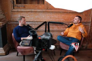 Edoardo Dusi interviewing Dominik from Sunzinet at JoyConf Amsterdam, recorded in a cozy wooden room.