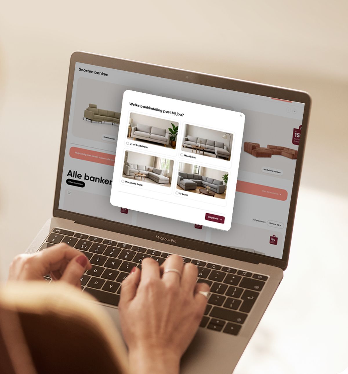 Person browsing a furniture website on a laptop, selecting a sofa from a pop-up window with images of different styles.