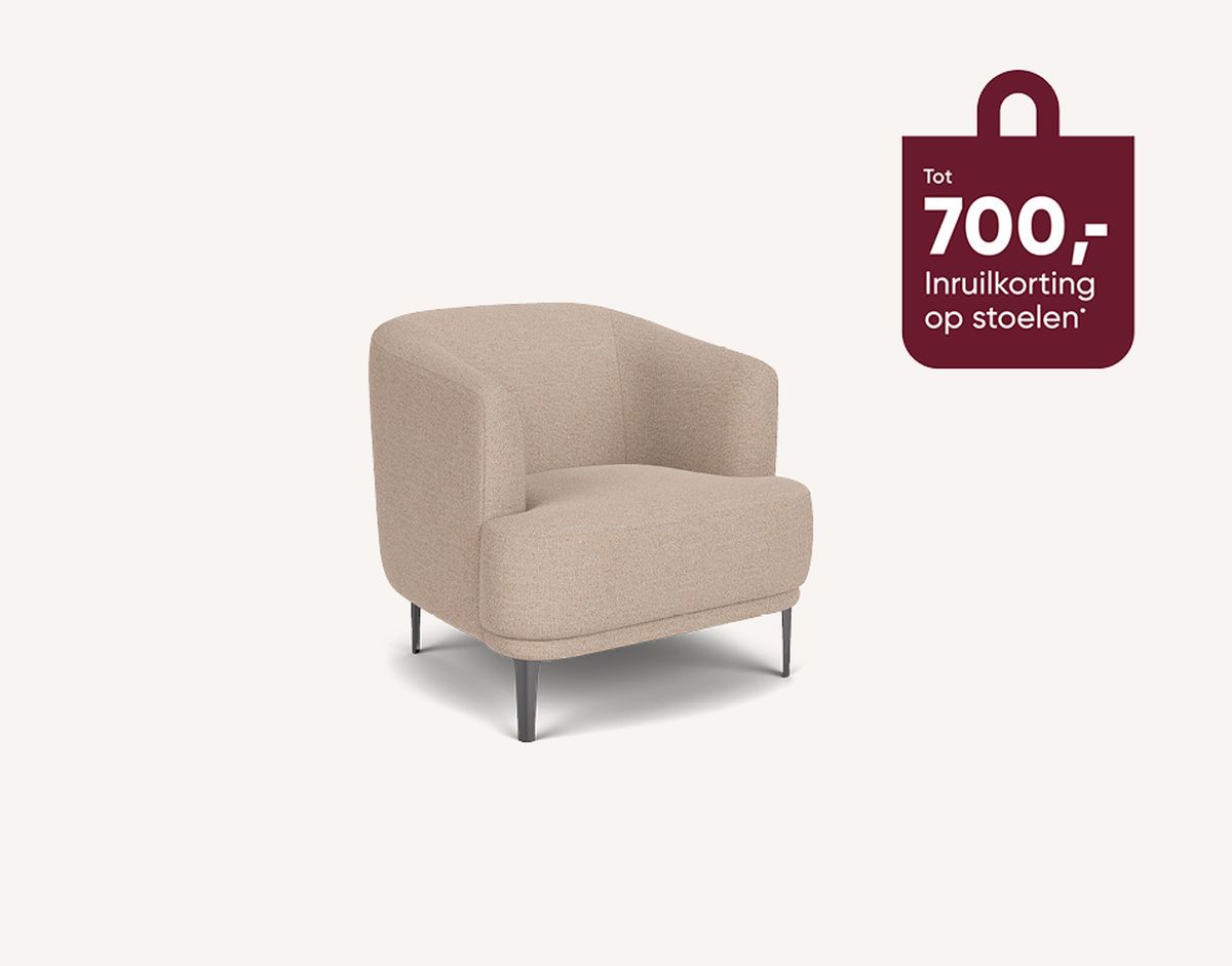 Beige armchair with black legs against a white background; a maroon tag reads "Tot 700,- Inruilkorting op stoelen" on the right.