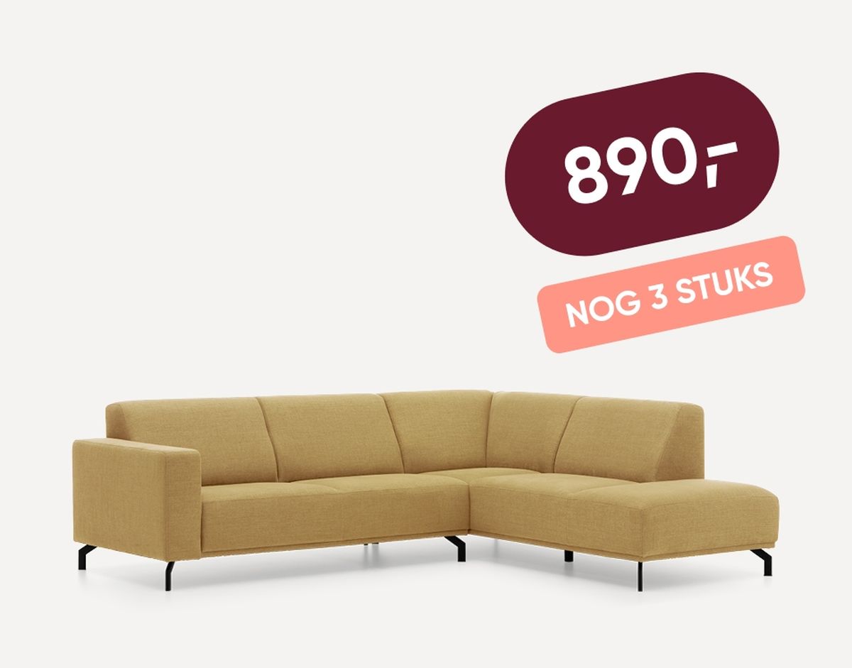 Yellow L-shaped sofa with black legs on a white background. Price tag reads "890" with a note saying "NOG 3 STUKS."