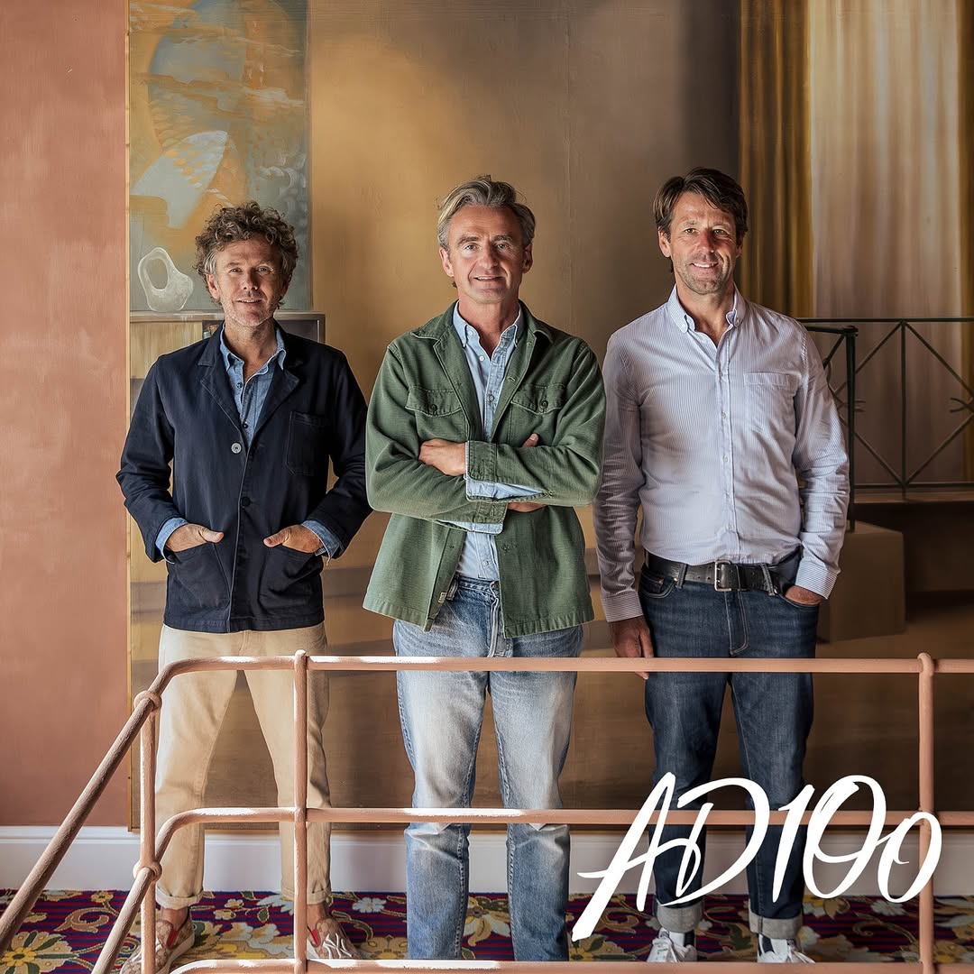 Three male designers standing together in front of a painted wall, featured in Architectural Digest AD100 2024