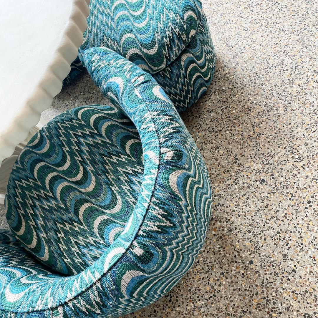 Carlton swivel chairs upholstered in blue patterned fabric, styled around a round table.