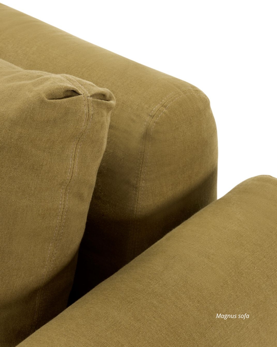 Detail of the Magnus sofa showing the textured fabric, stitching, and cushion seams in a warm olive tone.