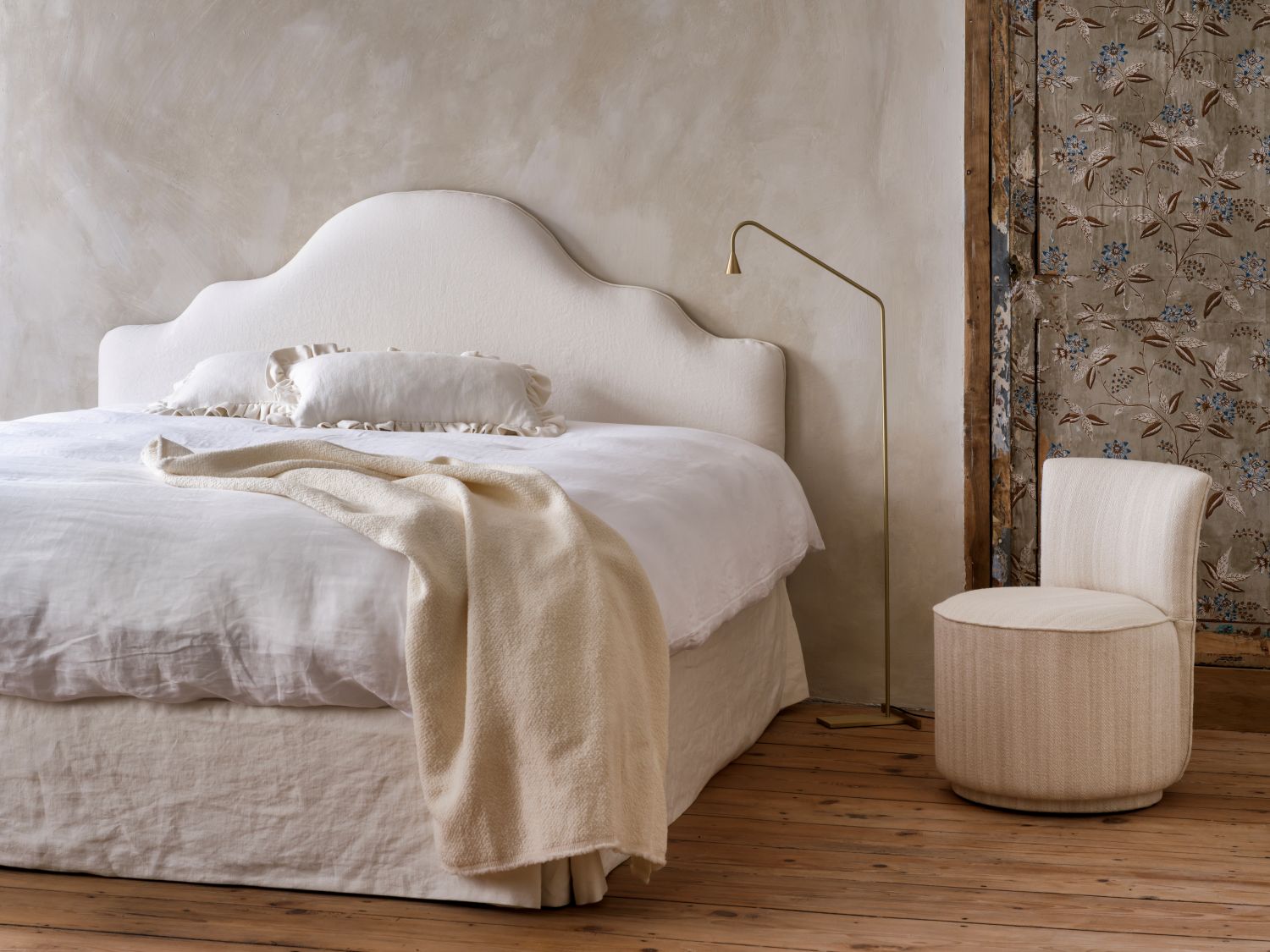 Jazz one-seater chair in cream fabric styled beside a luxury bed with headboard Lilly by Collett-Victor.