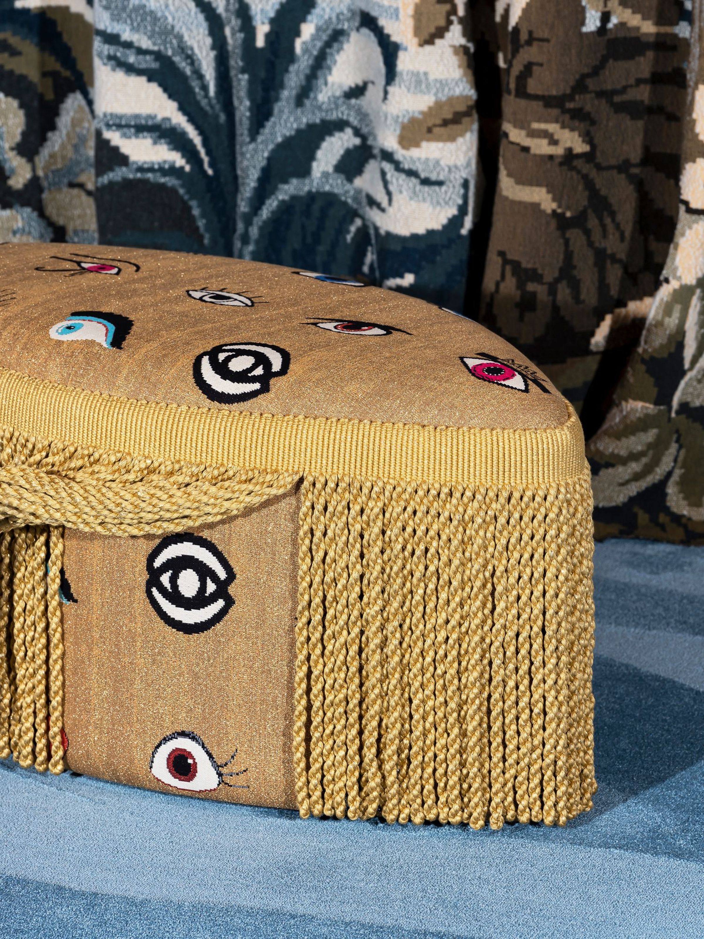 Cleopatra Pouf – luxurious golden pouf with embroidered eyes and gold fringe by Collett & Victor