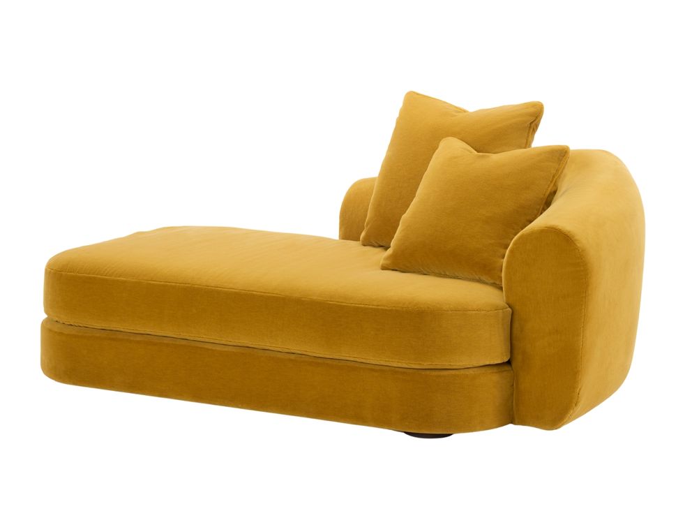 A luxurious yellow velvet chaise longue with rounded arms and soft cushions, offering a cozy and stylish seating option. The chaise longue has a modern and elegant design, featuring a smooth fabric texture and a relaxed, inviting shape.
