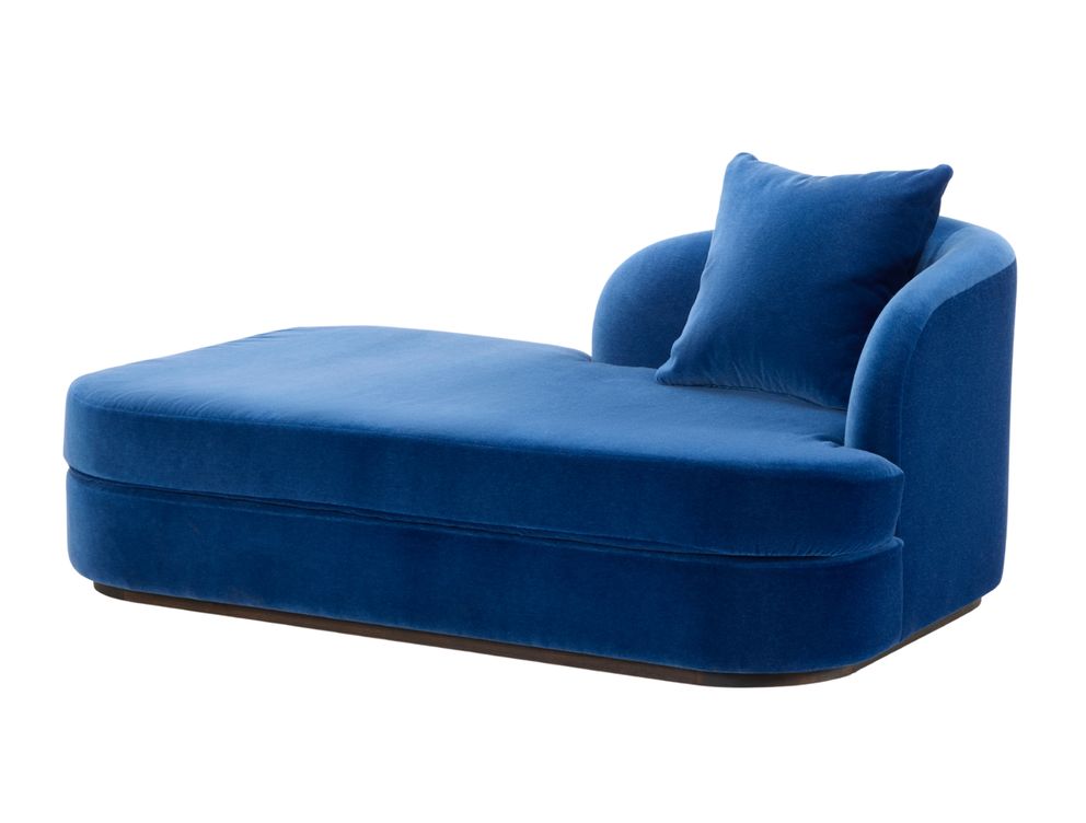 Elly chaise longue by Collett & Victor in deep blue velvet with curved backrest and cushion.