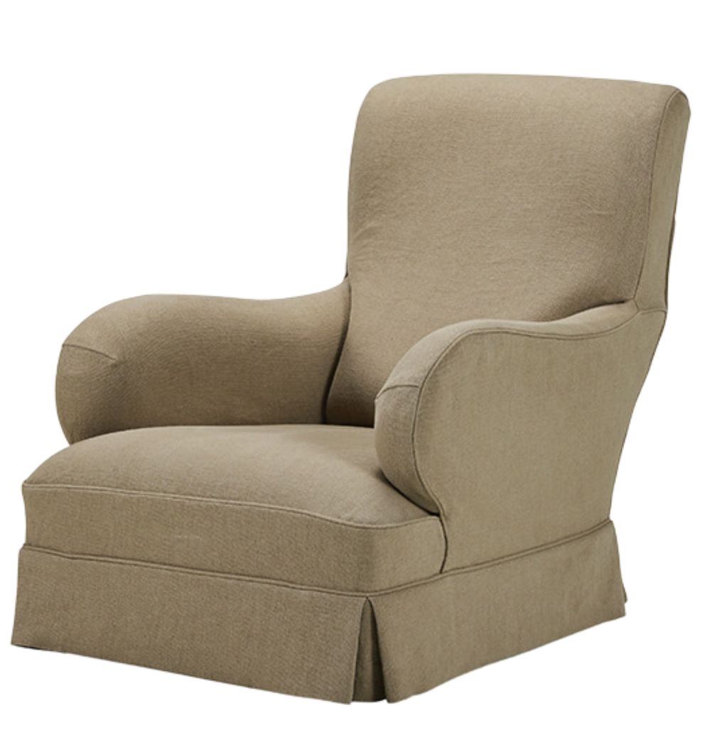 A beige armchair with a rounded backrest, soft fabric, curved arms, and a pleated skirt base.