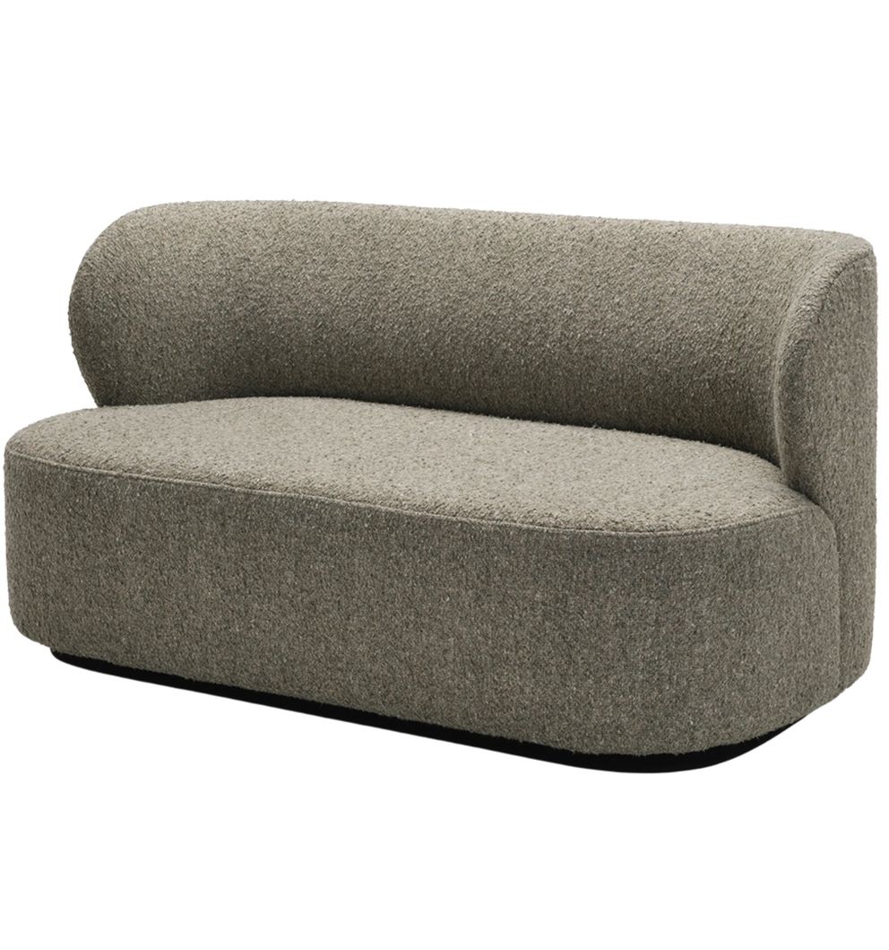 A minimalist loveseat with a rounded backrest and low-profile design, upholstered in a neutral grayish fabric, featuring a soft, sculptural form.