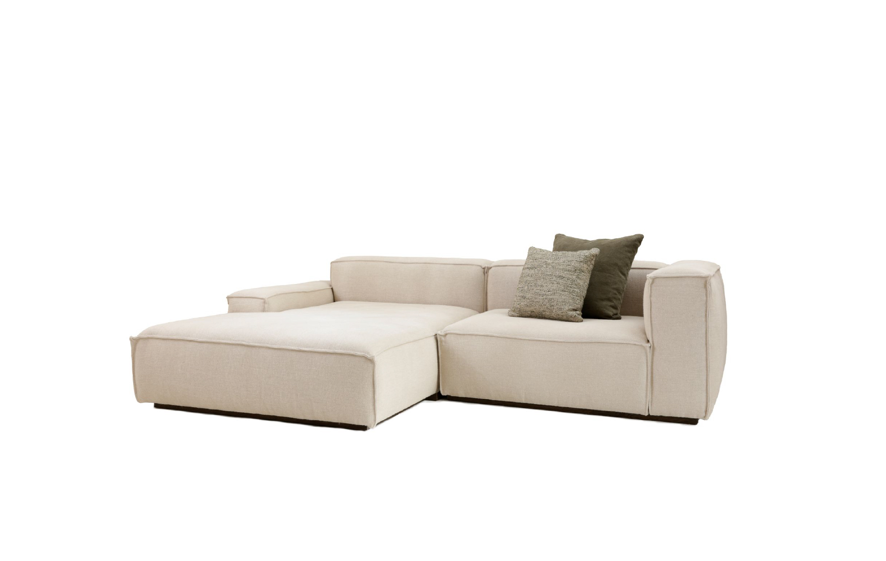 Beige Dix sectional sofa with wide chaise lounge, boxy arms, and green accent cushions by Collett & Victor.