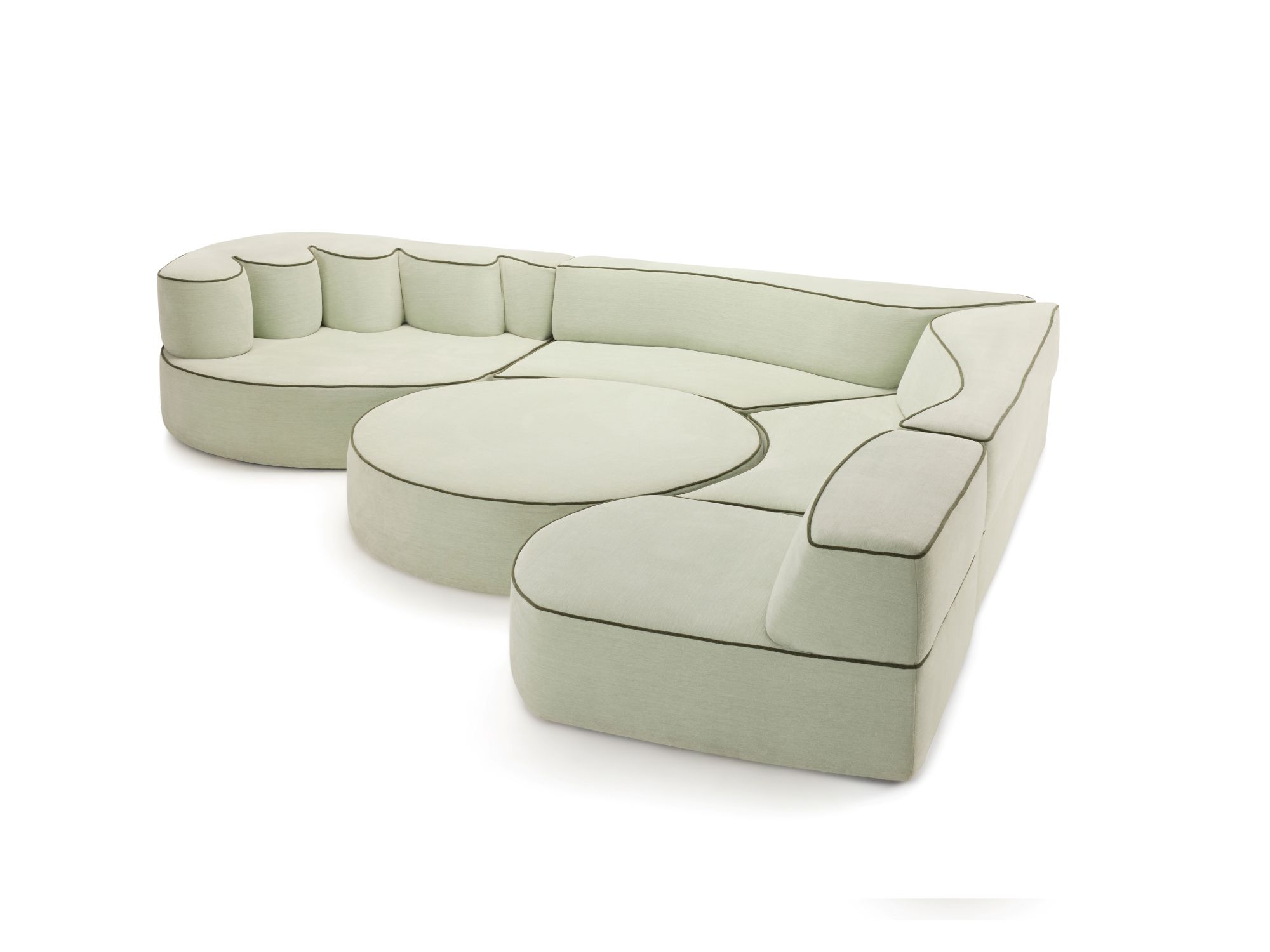 Modular Comporta sofa in pale green upholstery with dark piping, featuring organic, rounded forms and a central circular cushion element.