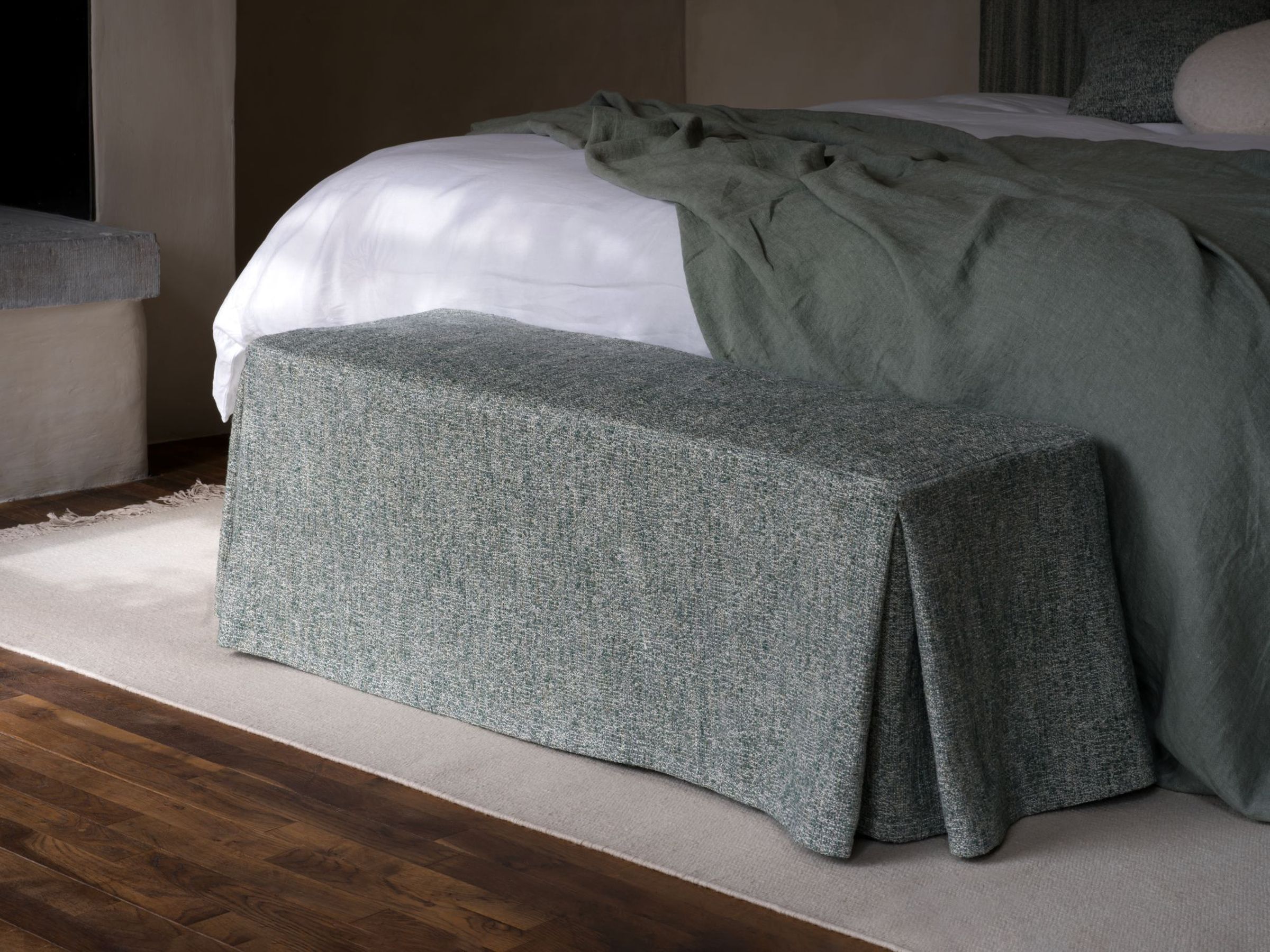 Collett & Victor Postal Bench upholstered in textured green fabric, elegant bed bench for refined bedroom interiors.