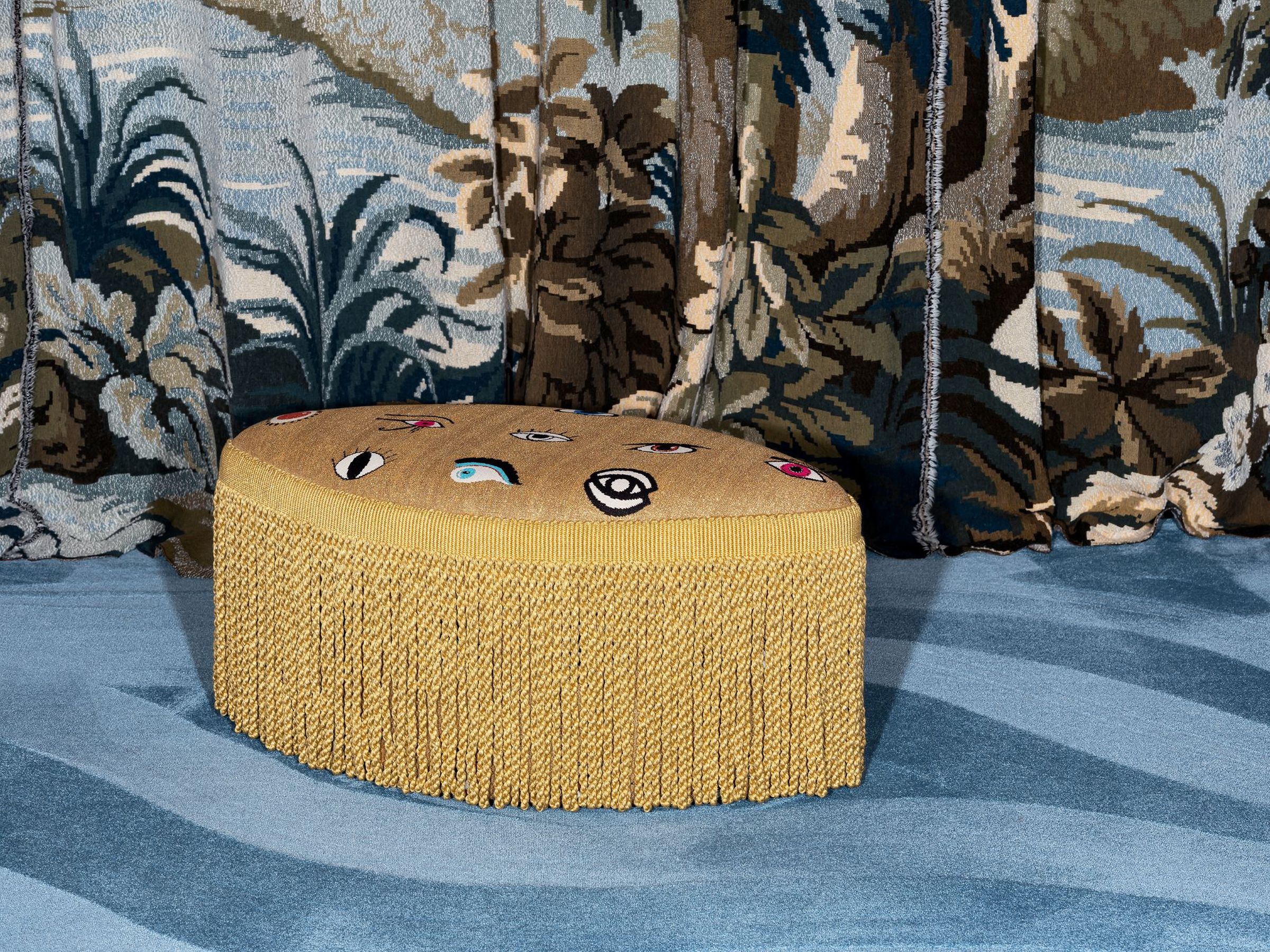 Cleopatra Pouf – luxury decorative pouf in golden fabric with embroidered eye motifs and long fringe by Collett & Victor