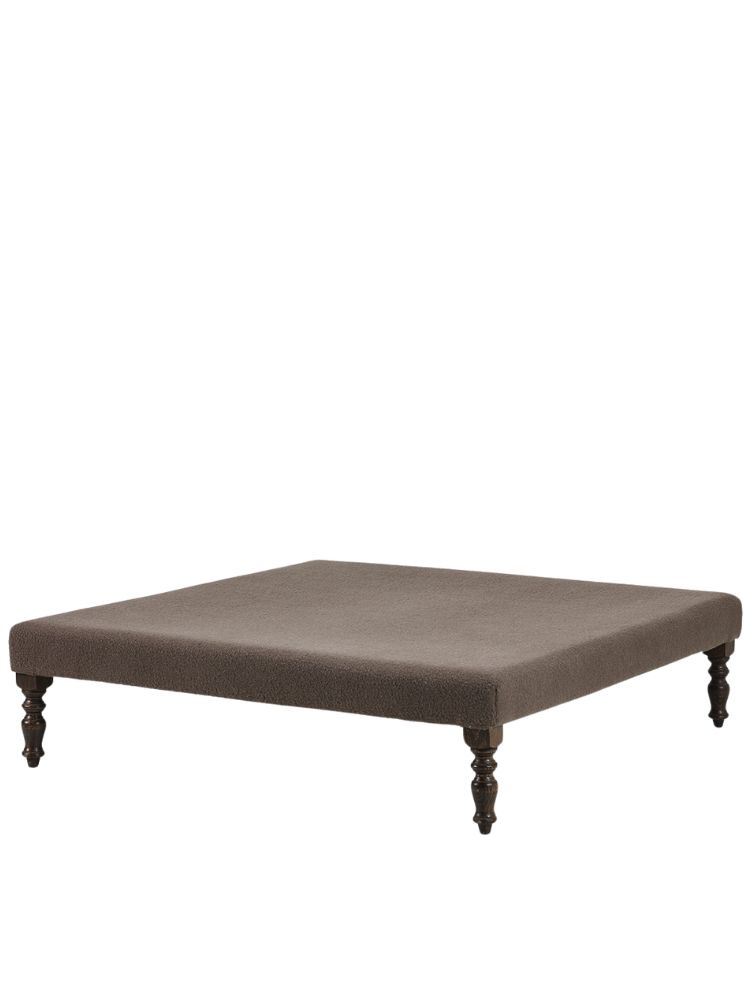 Collett & Victor Marbella pouf in brown fabric with elegant turned wooden legs.
