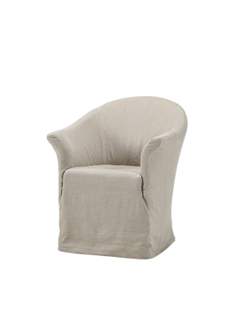 Thibaut dining chair by Collett & Victor, upholstered in light beige linen with rounded arms and a fitted slipcover design.