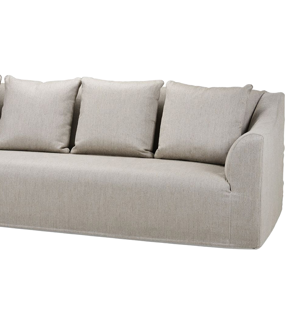 Close-up of the Toscana fixed seat sofa in light beige fabric with three large back cushions and gently curved armrest by Collett & Victor.