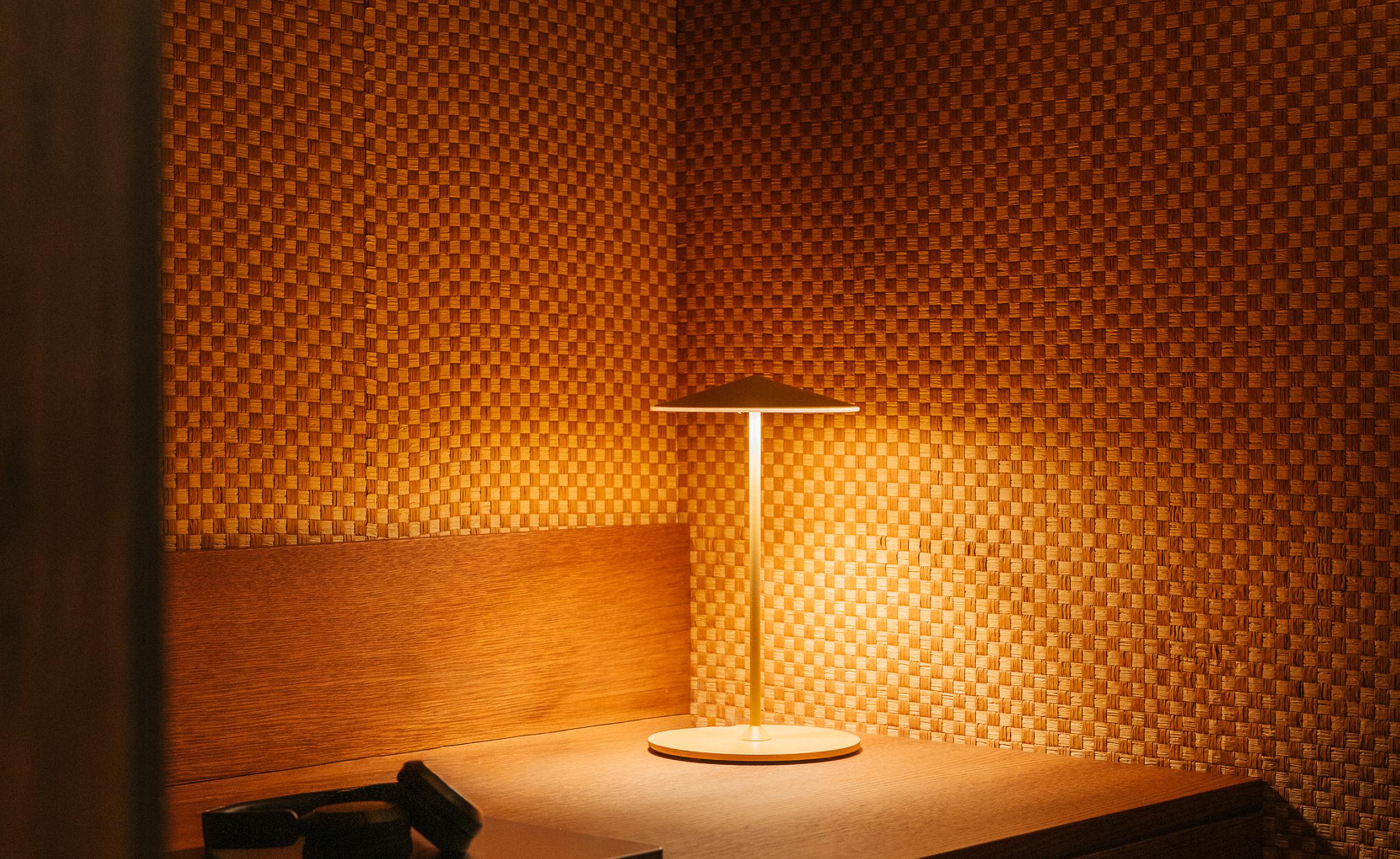Image of a cosy work nook with lamp and desk, The Draper luxury flats to rent co-working space. [G]