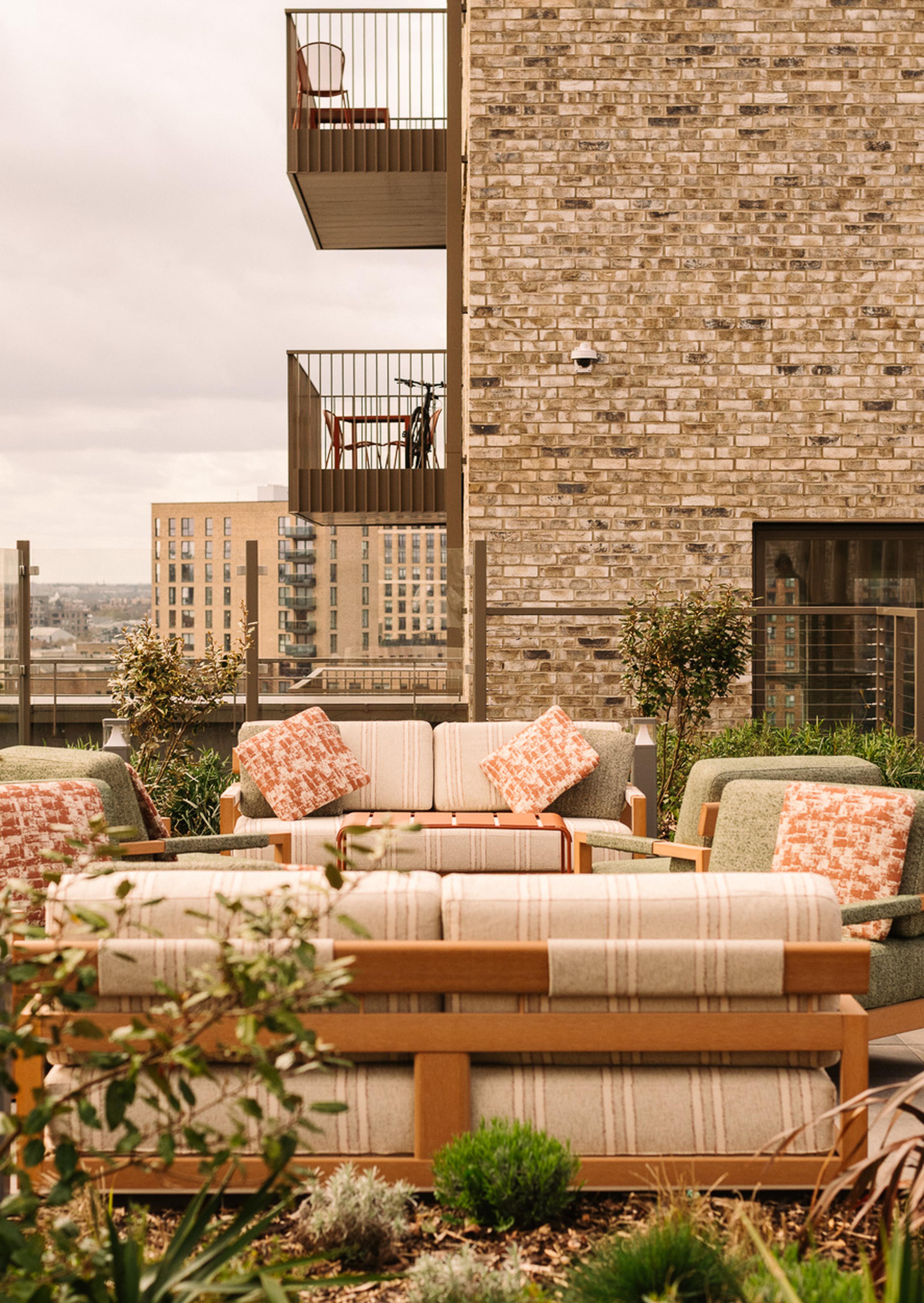 Image of rooftop terrace lounge with balconies at The Draper luxury apartments to rent. [G]