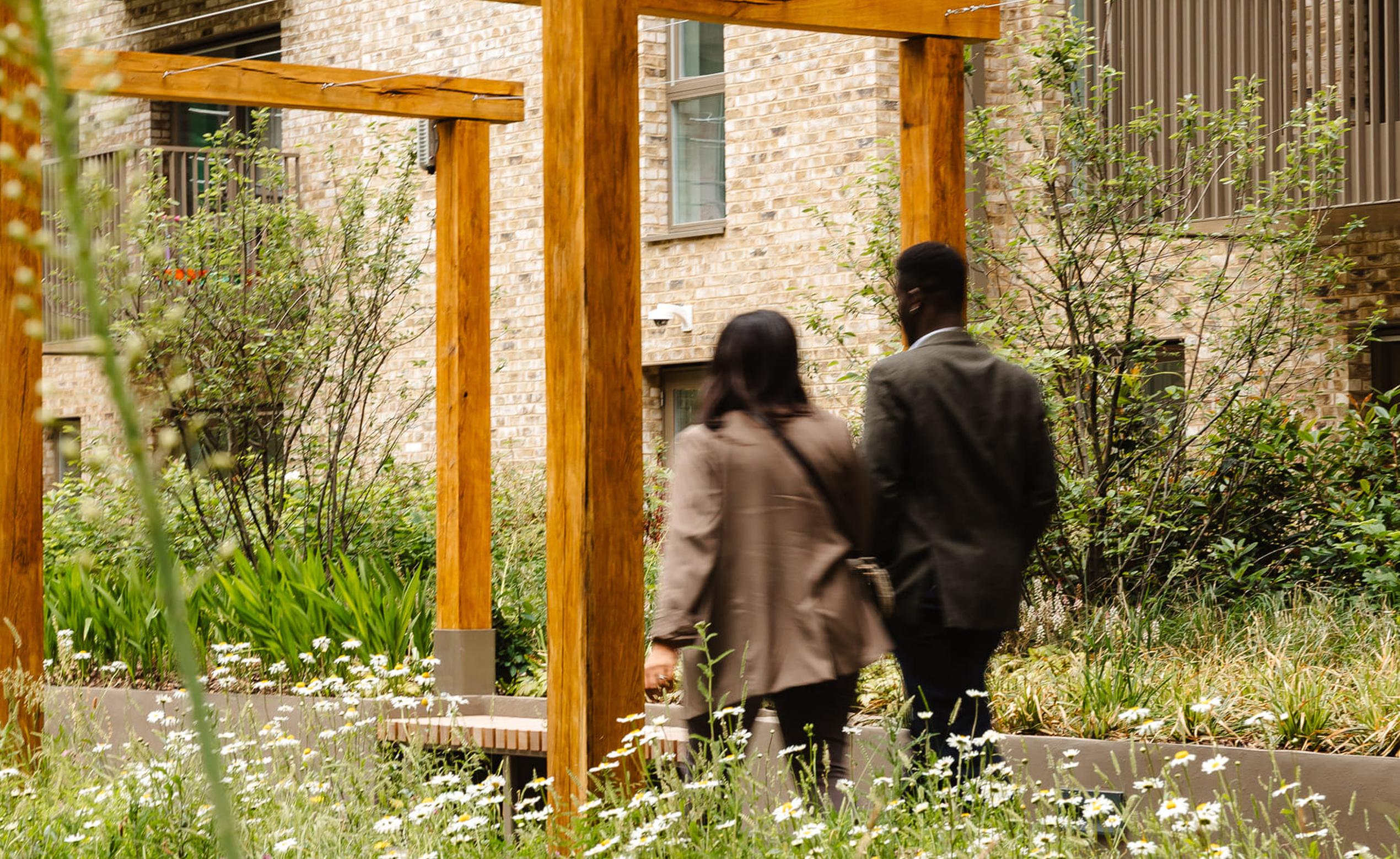 Couple walking through the gardens at Beaufort Park Spa & Gardens, London