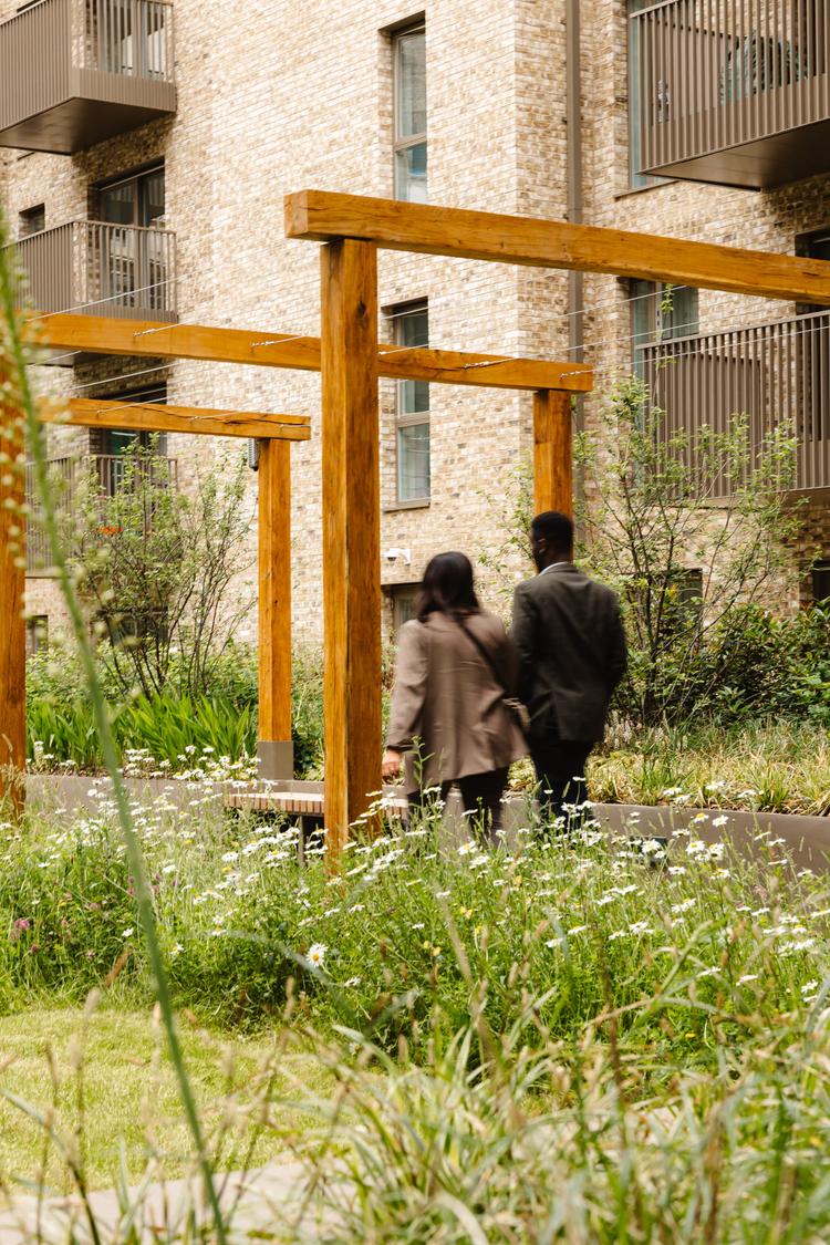 Couple walking through the gardens at Beaufort Park Spa & Gardens, London