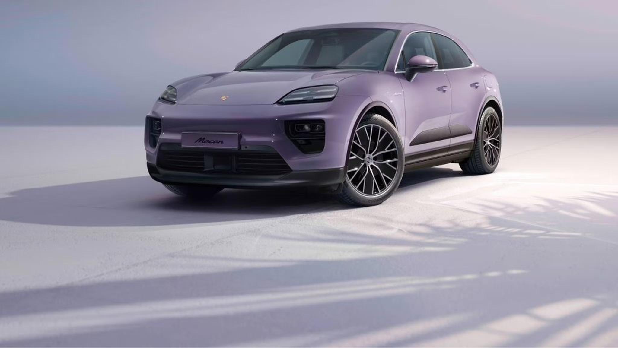 Electric Porsche Macan charging at a station, symbolizing Porsche’s electric future.