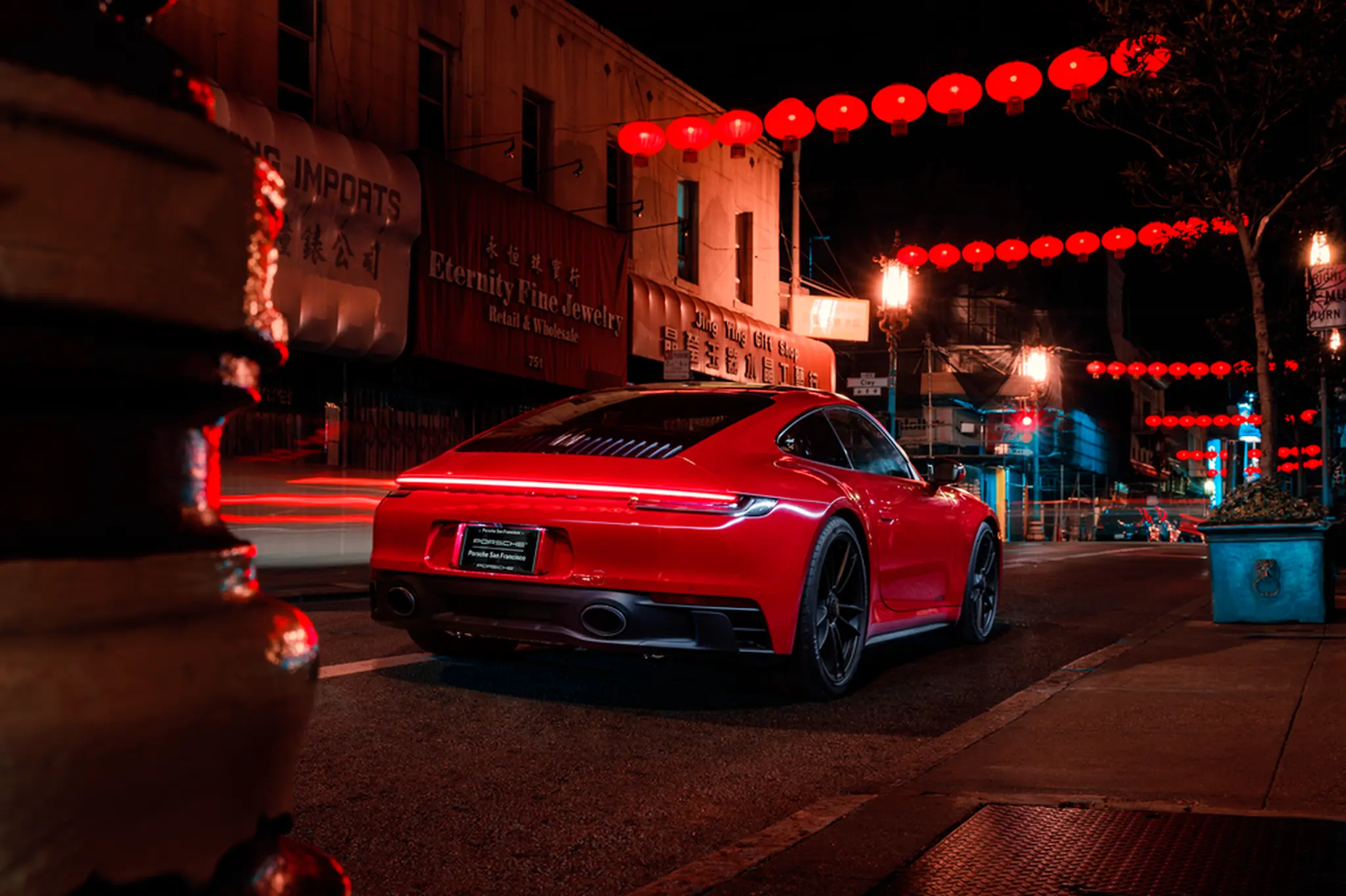 Red Porsche 911 in San Francisco's Chinatown at night