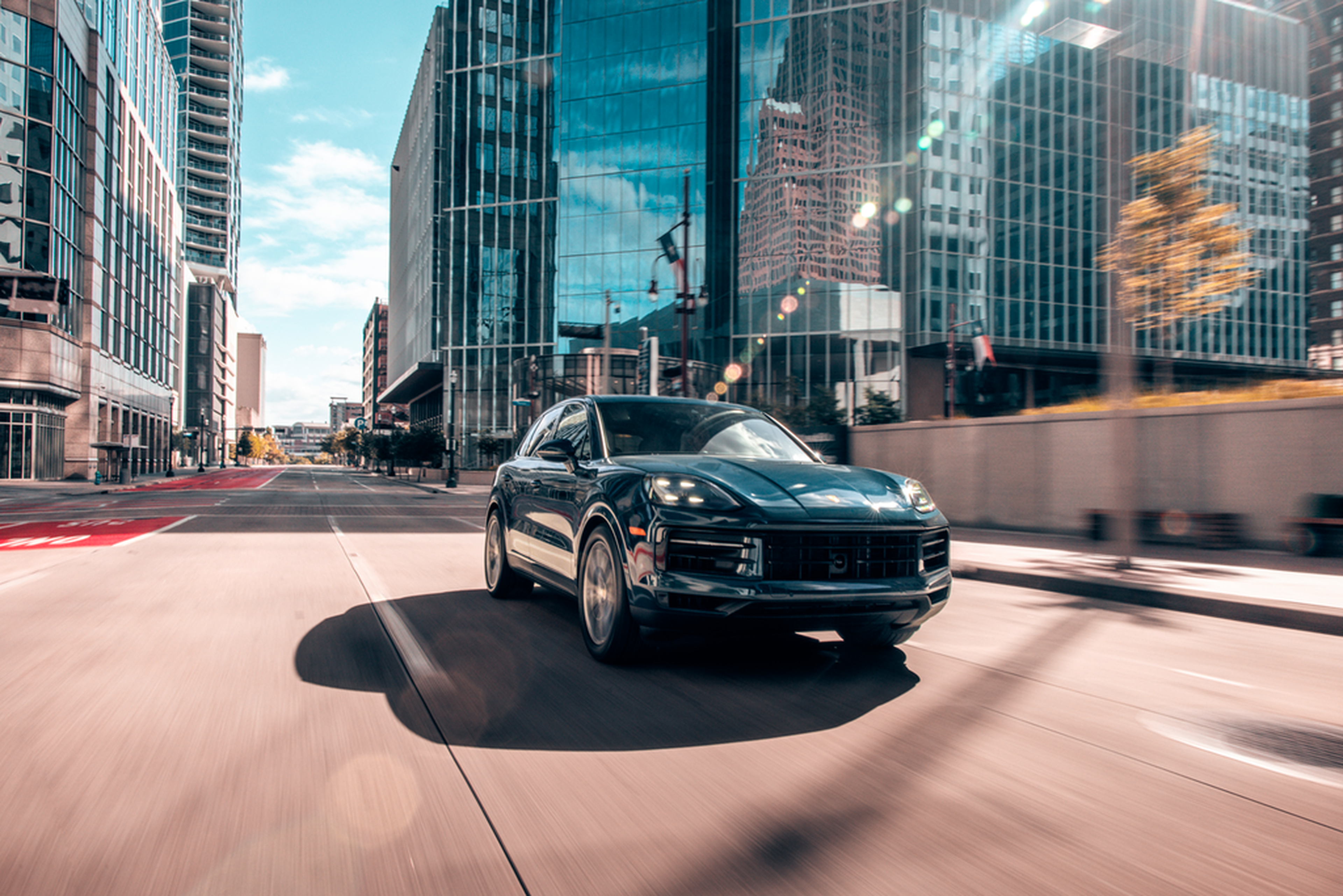 Porsche Cayenne among downtown glass towers