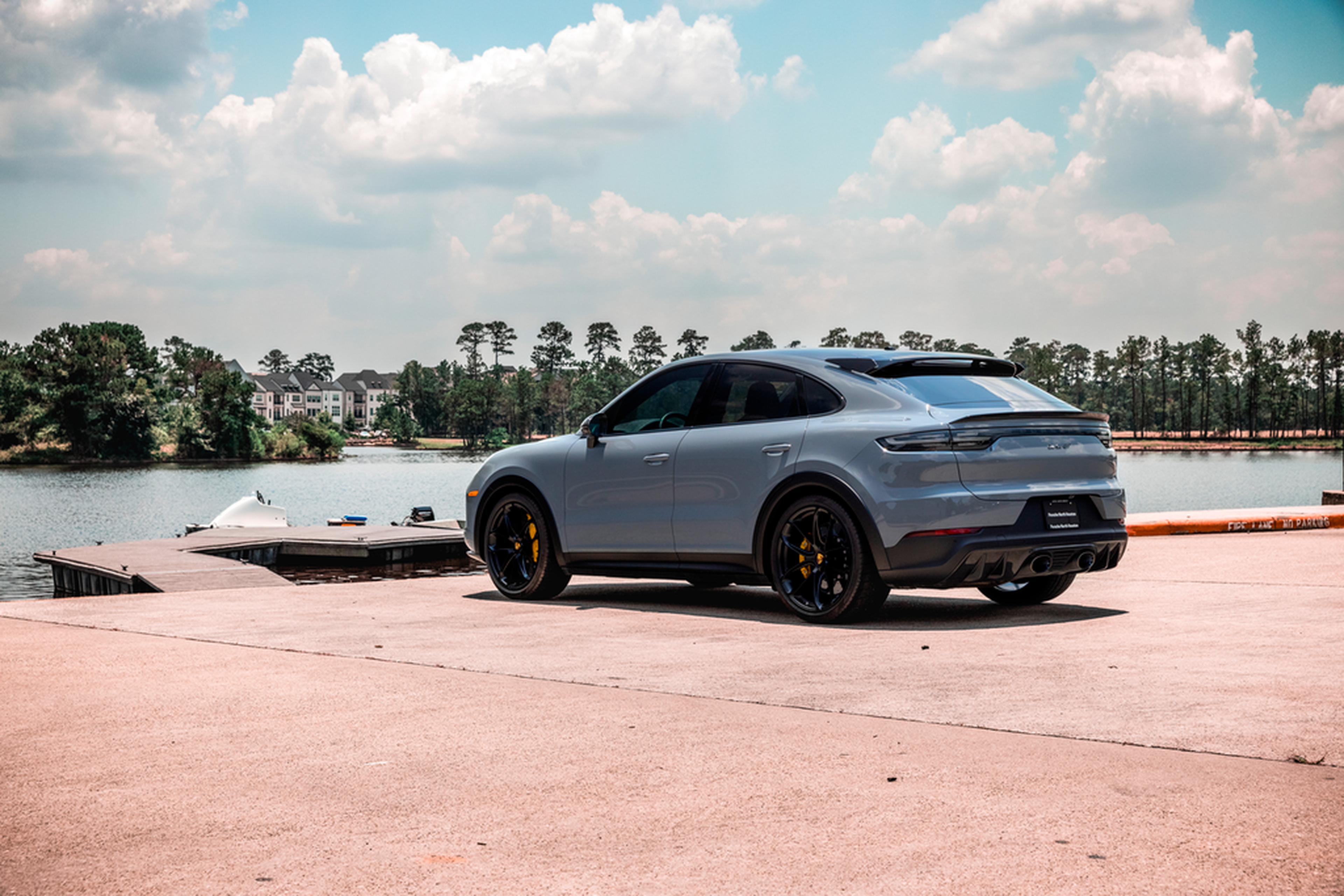 Gray Porsche Cayenne Coupe by the water