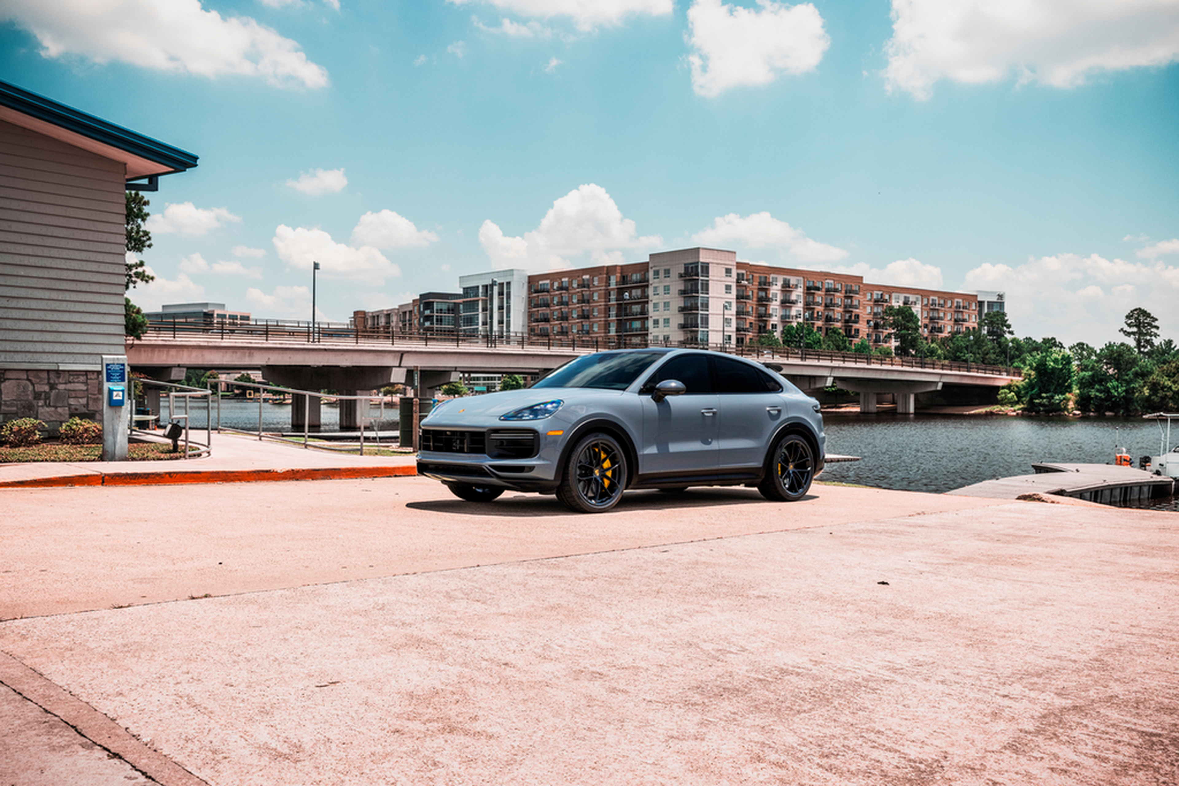 Teal Porsche Cayenne on a waterfront