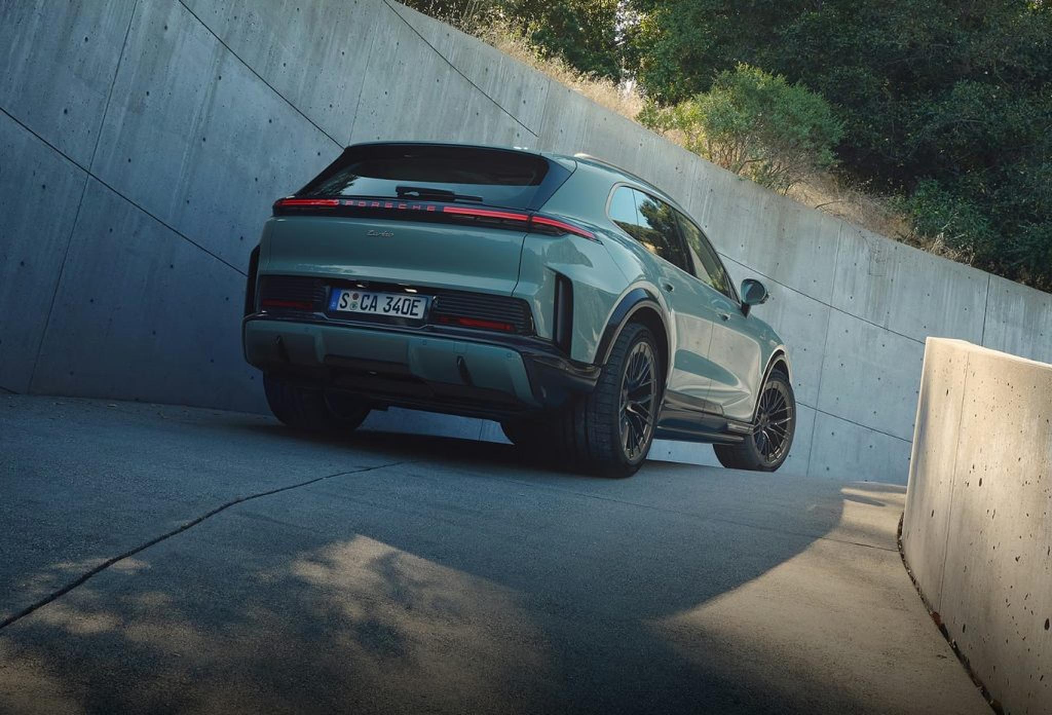 Rear view of a Porsche Cayenne Turbo driving uphill, highlighting the benchmark luxury performance SUV lineup.