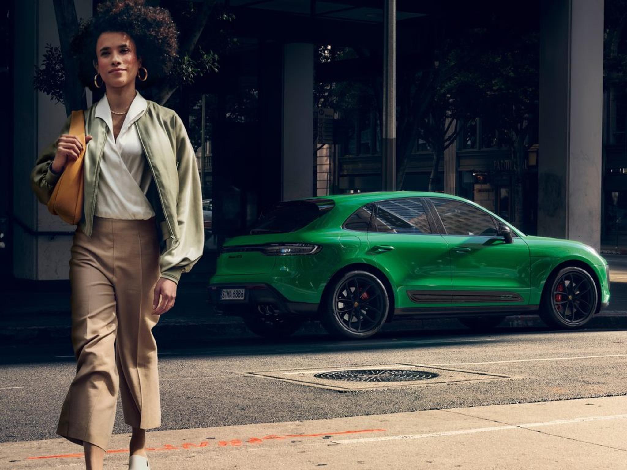 Driver enjoying the 2026 Porsche Macan GTS on the open road, blending performance and refinement.
