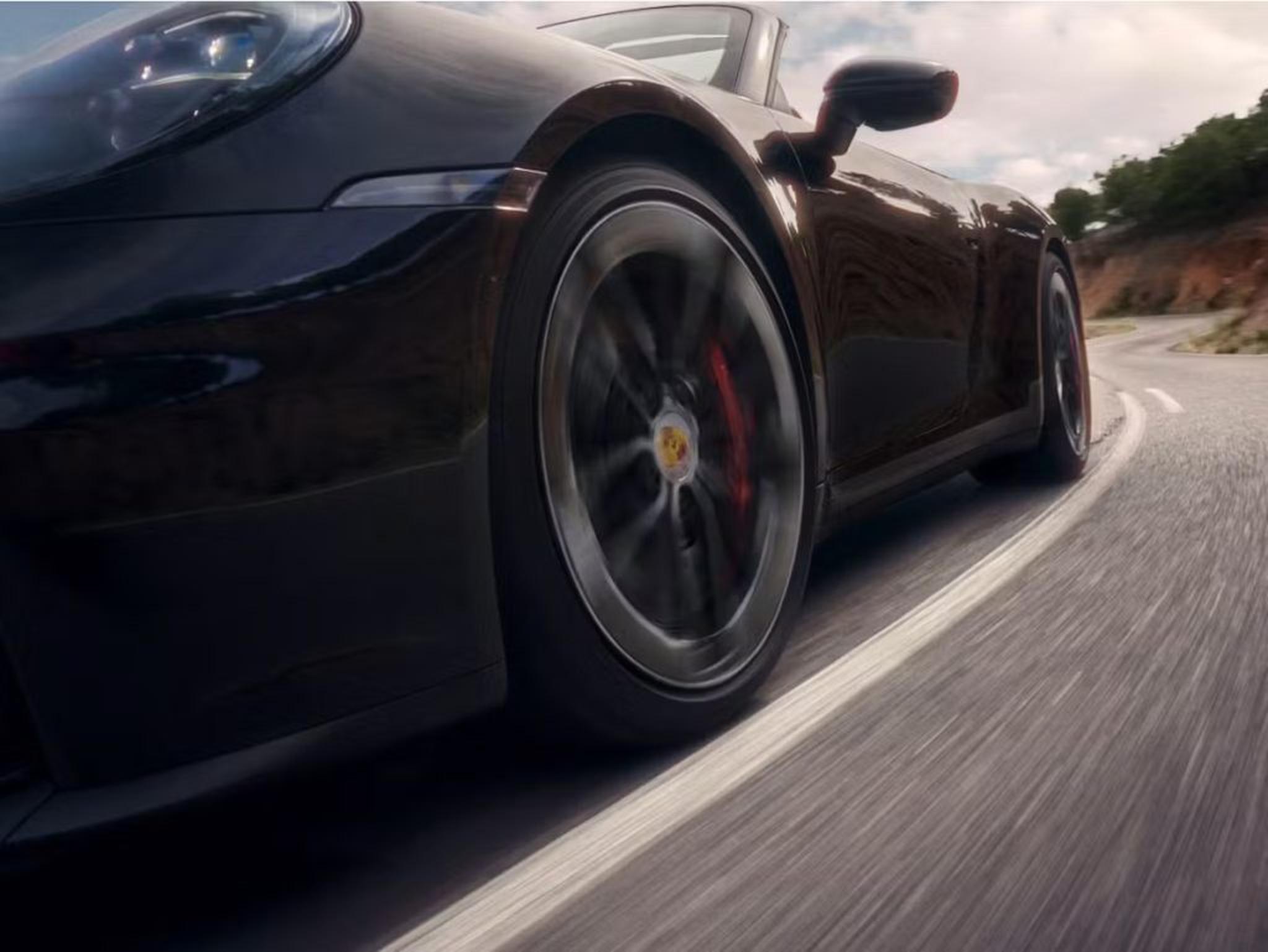 Porsche sports car on the road symbolizing the joy of ownership for both new and Certified Pre-Owned Porsche buyers.