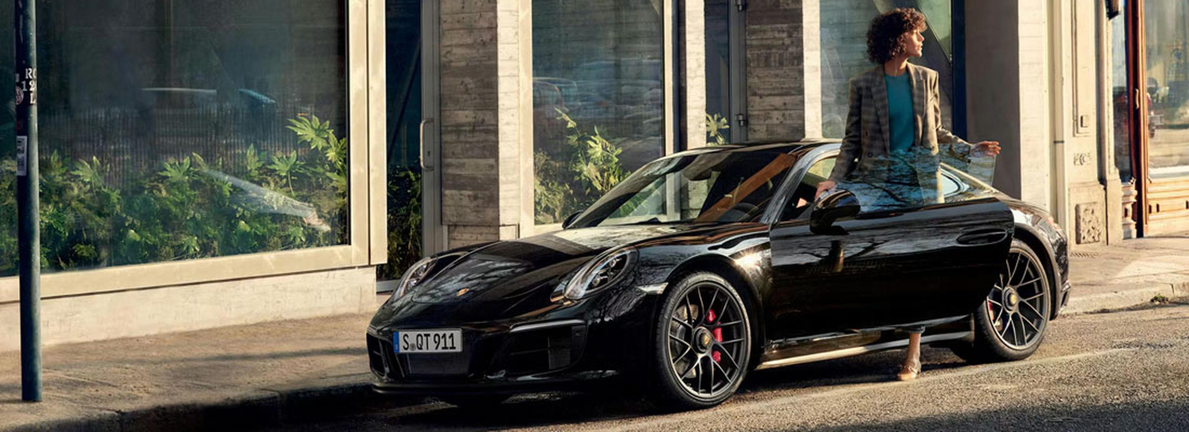 Driver Getting Into Black Porsche Certified Pre-Owned Vehicle