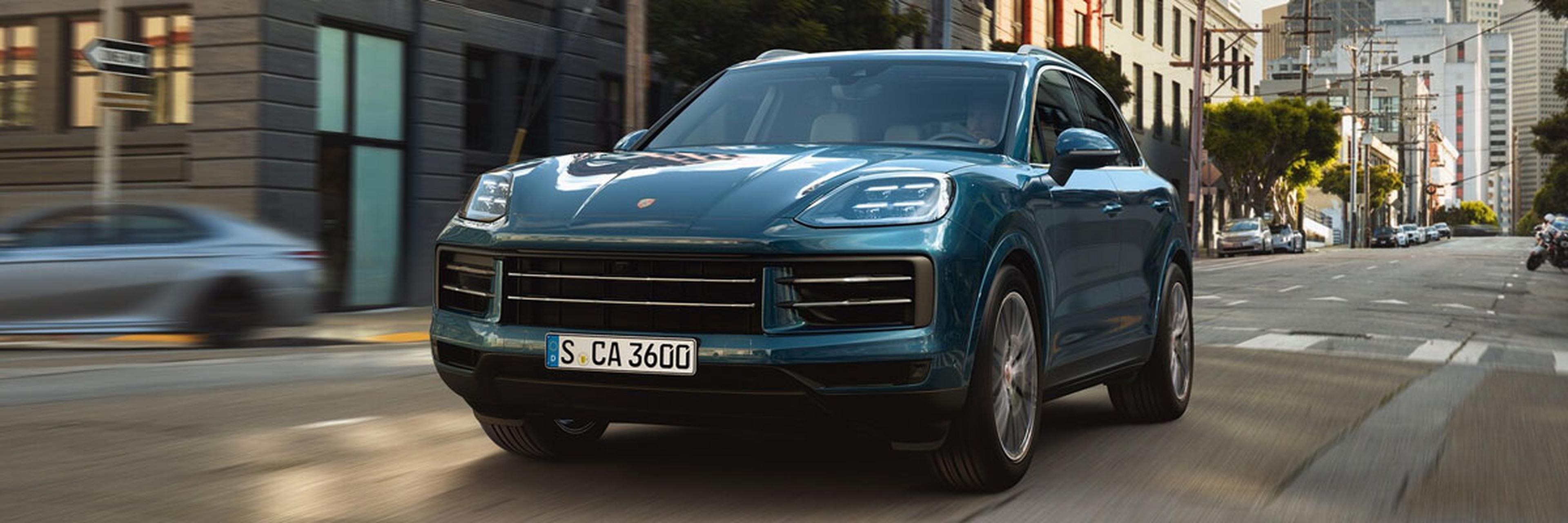 Blue 2027 Porsche Cayenne Driving Down Street