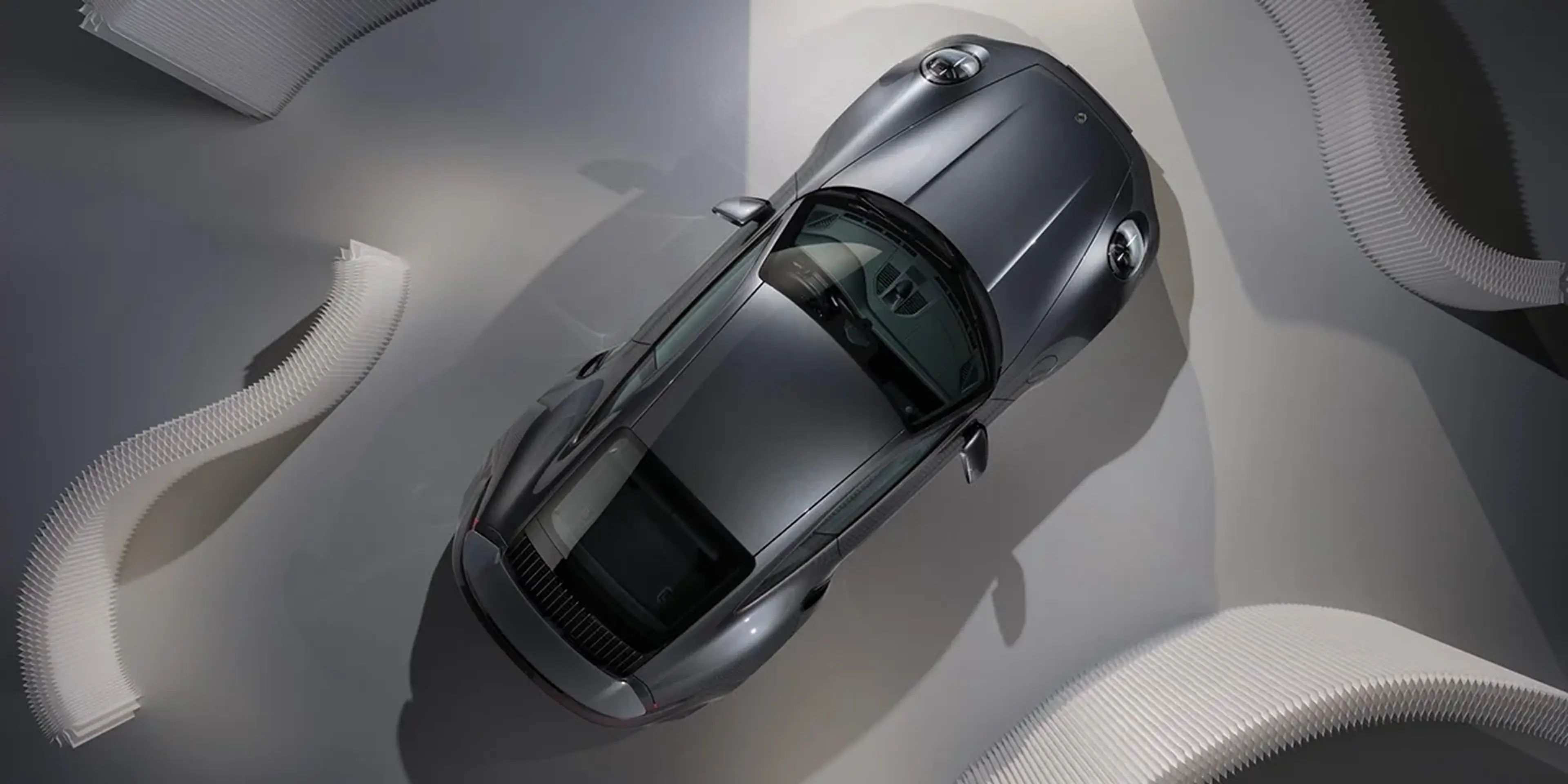 2026 Porsche 911 Turbo S lineup featuring coupe and cabriolet models in a modern studio setting.