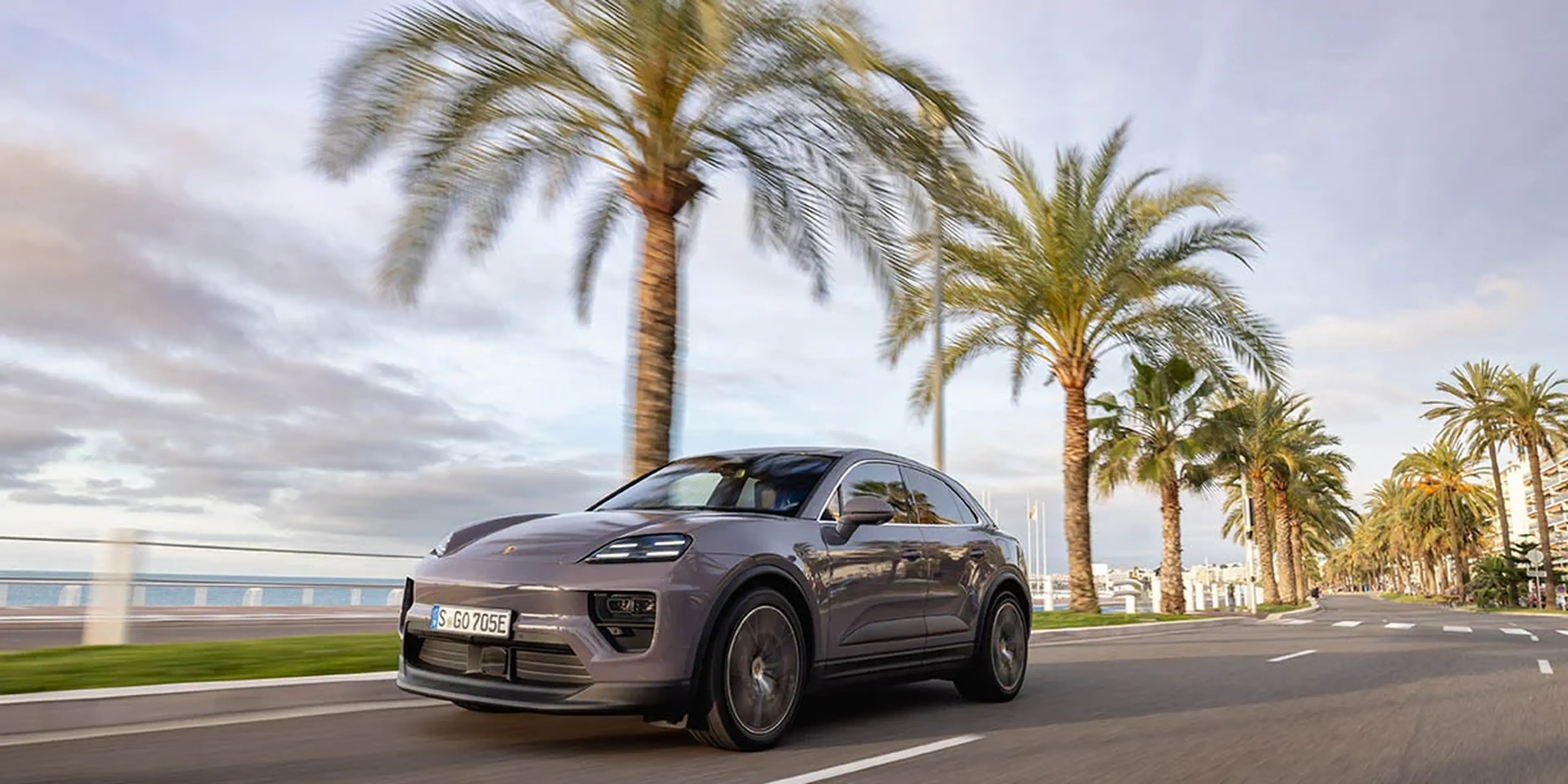 Gray 2025 Porsche Macan 4 Electric parked under palm trees