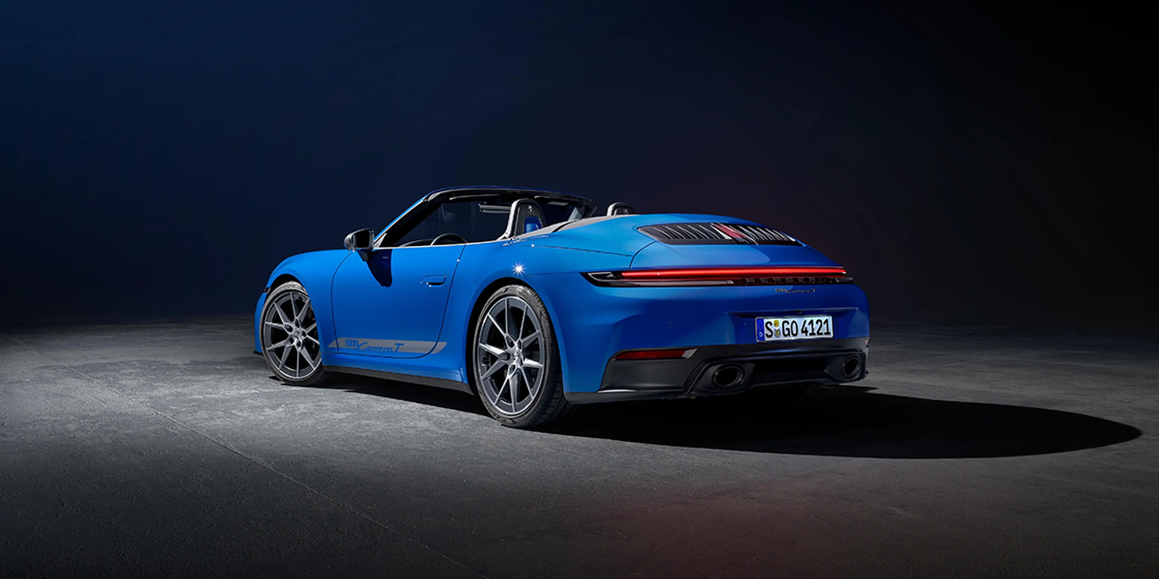 Blue 2025 Porsche 911 Carrera T Cabriolet front three-quarter view