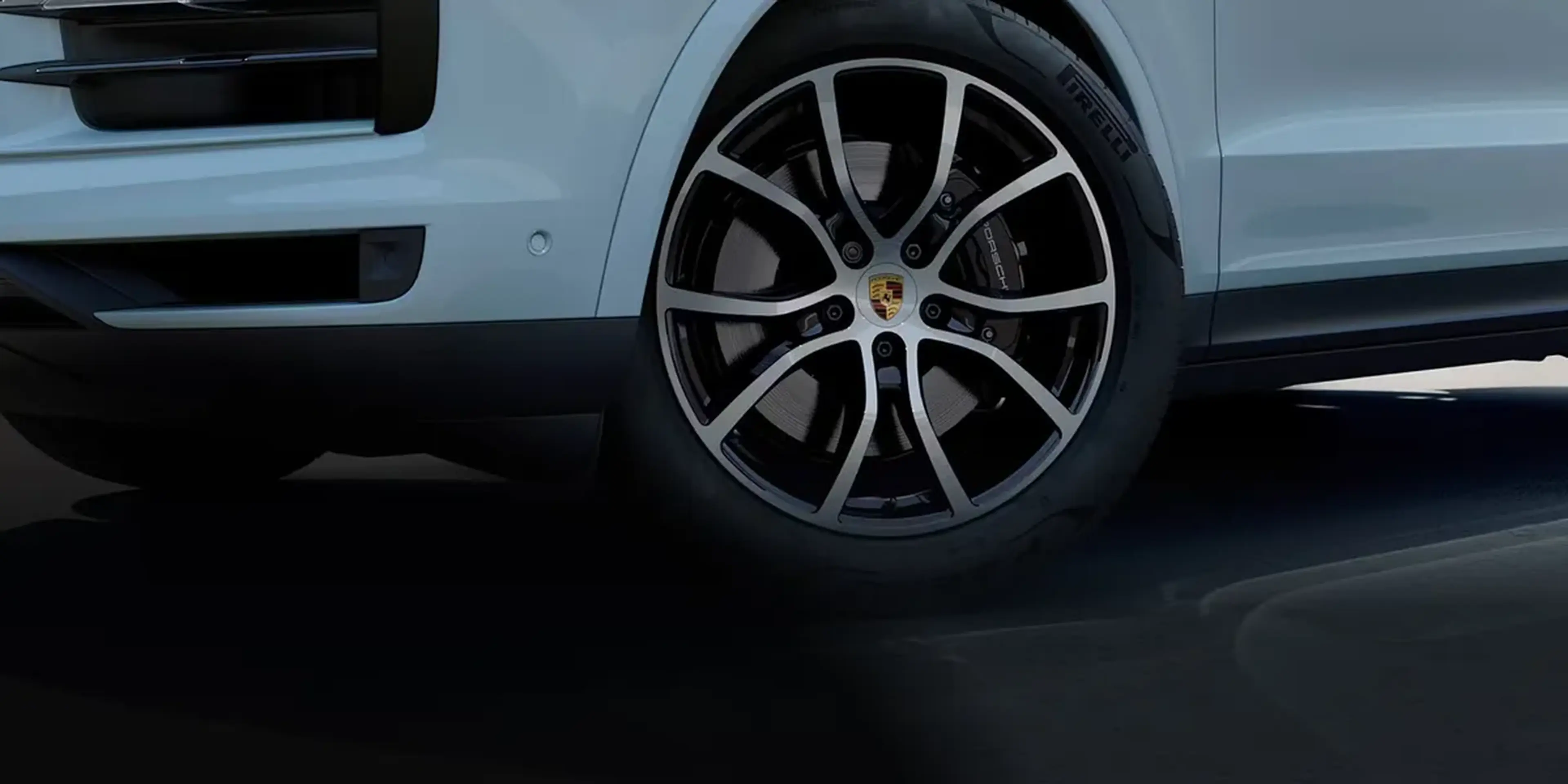 Close-up of the 2026 Porsche Cayenne front wheel with black alloy rim and performance-tuned suspension.