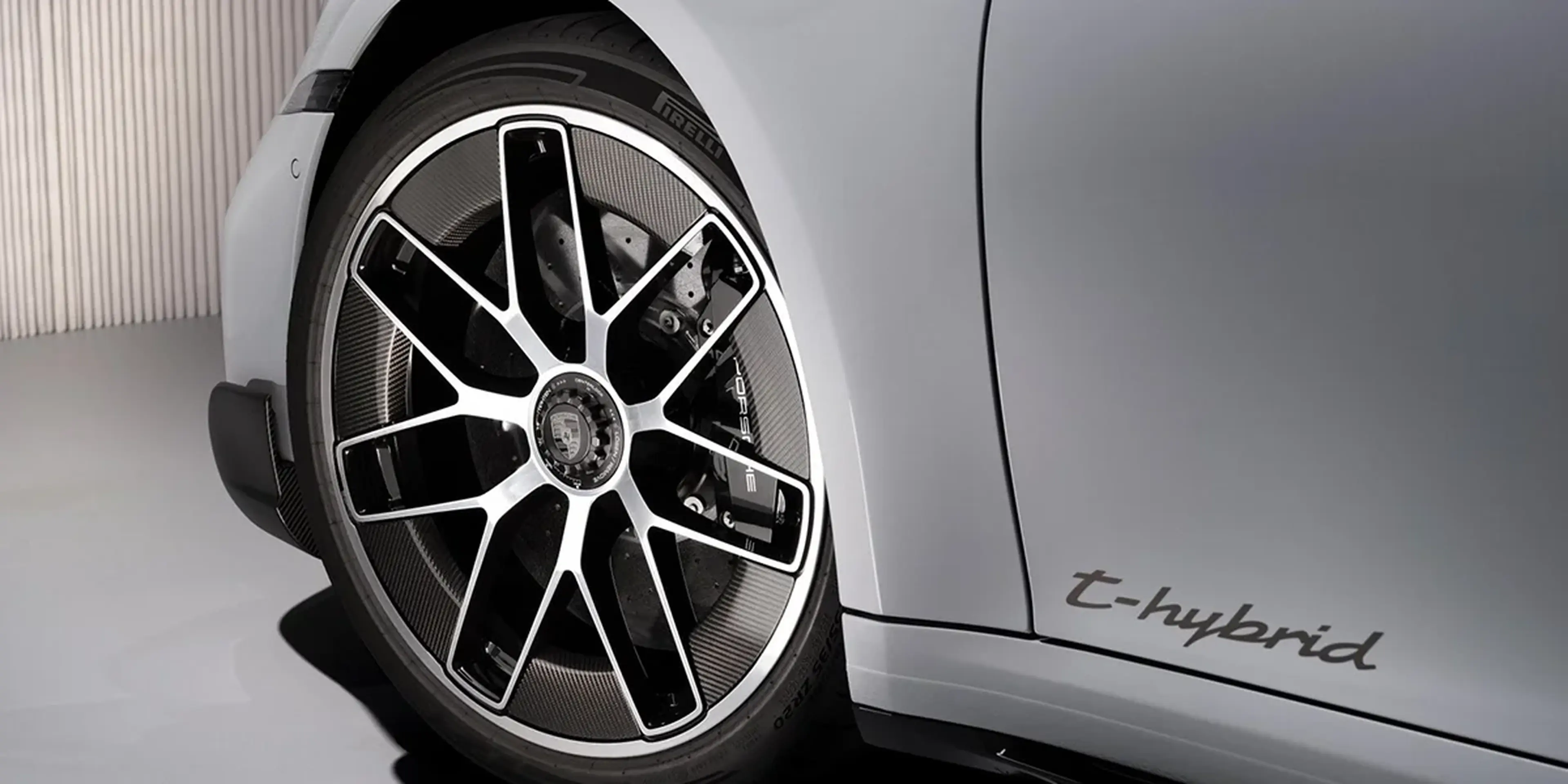 Close-up of Porsche 911 Turbo S Cabriolet rear section, showcasing spoiler, taillights, and Turbo S badge.