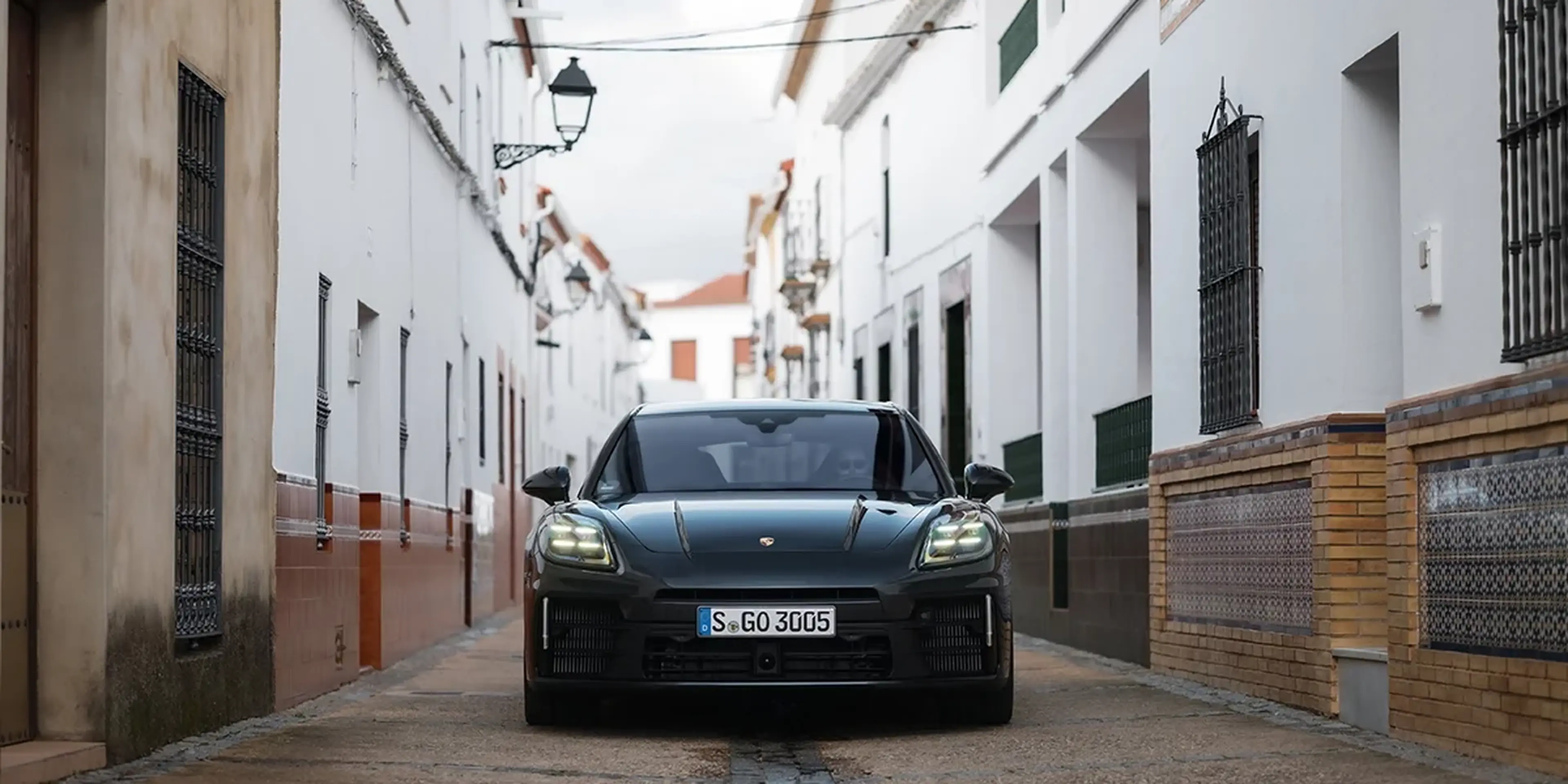 Black 2025 Porsche Panamera on a white village street