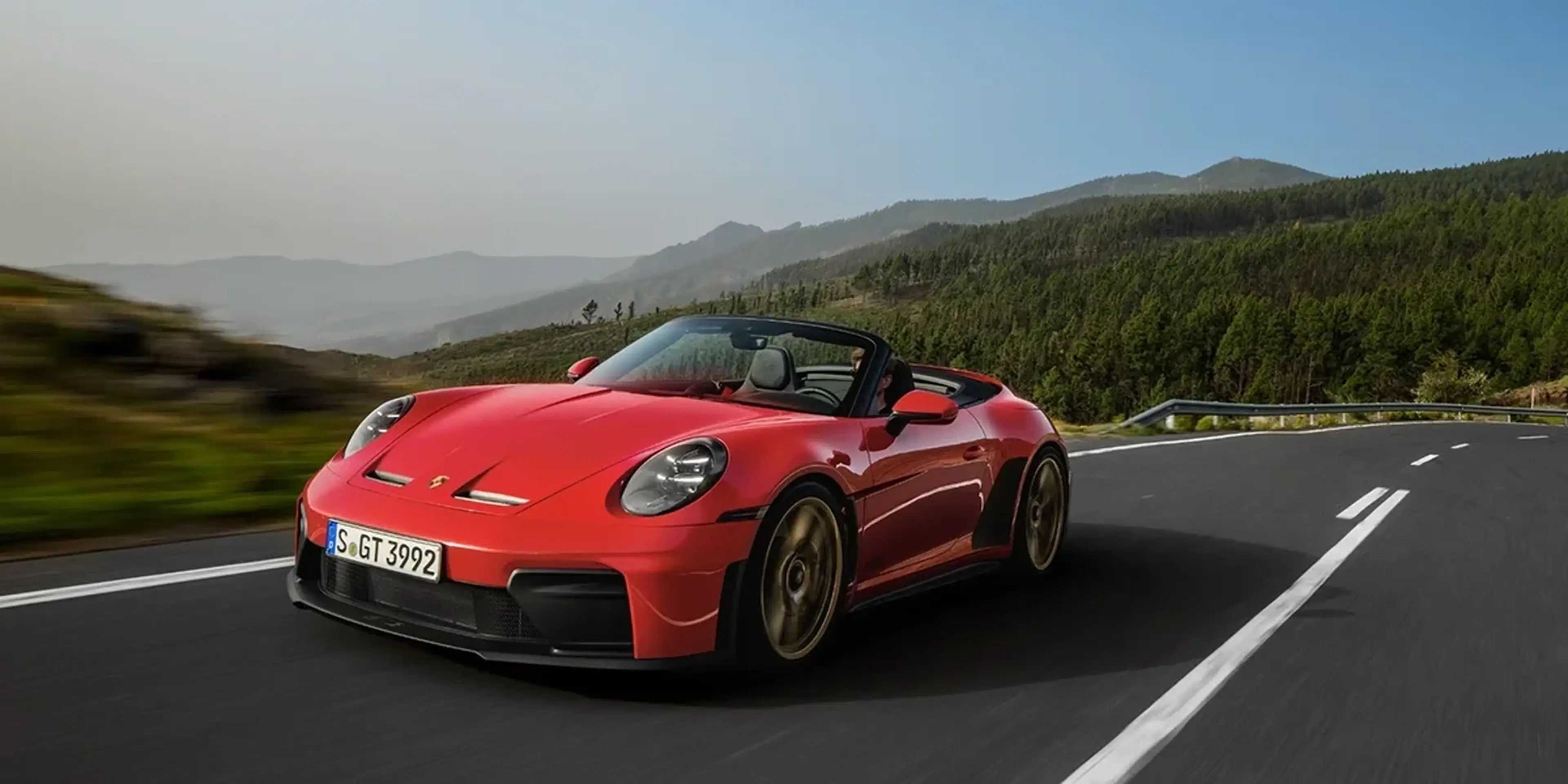 Red 2027 Porsche 911 GT3 S/C Cabriolet on a mountain road