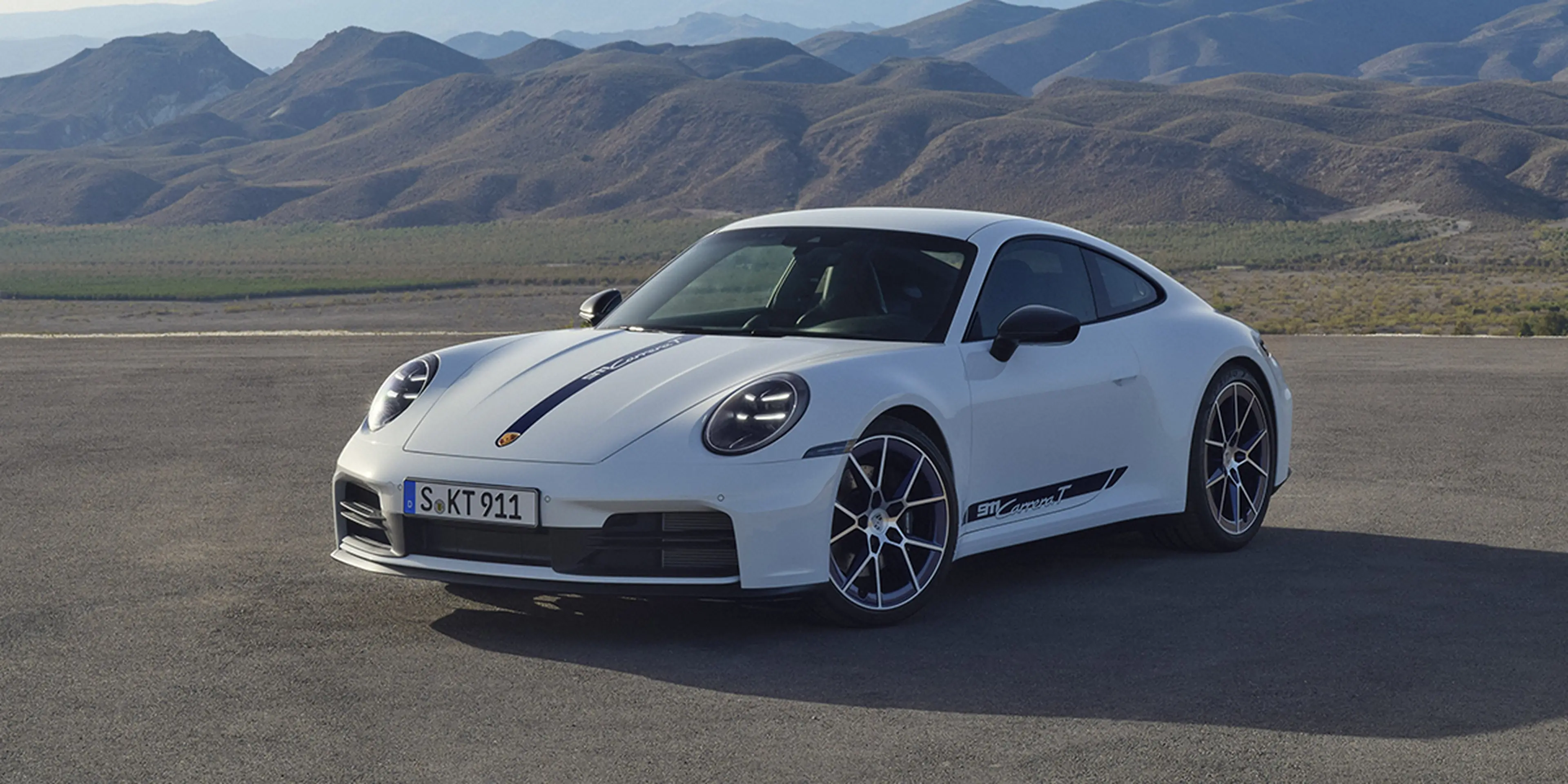 White 2025 Porsche 911 Carrera T with side stripes in the mountains