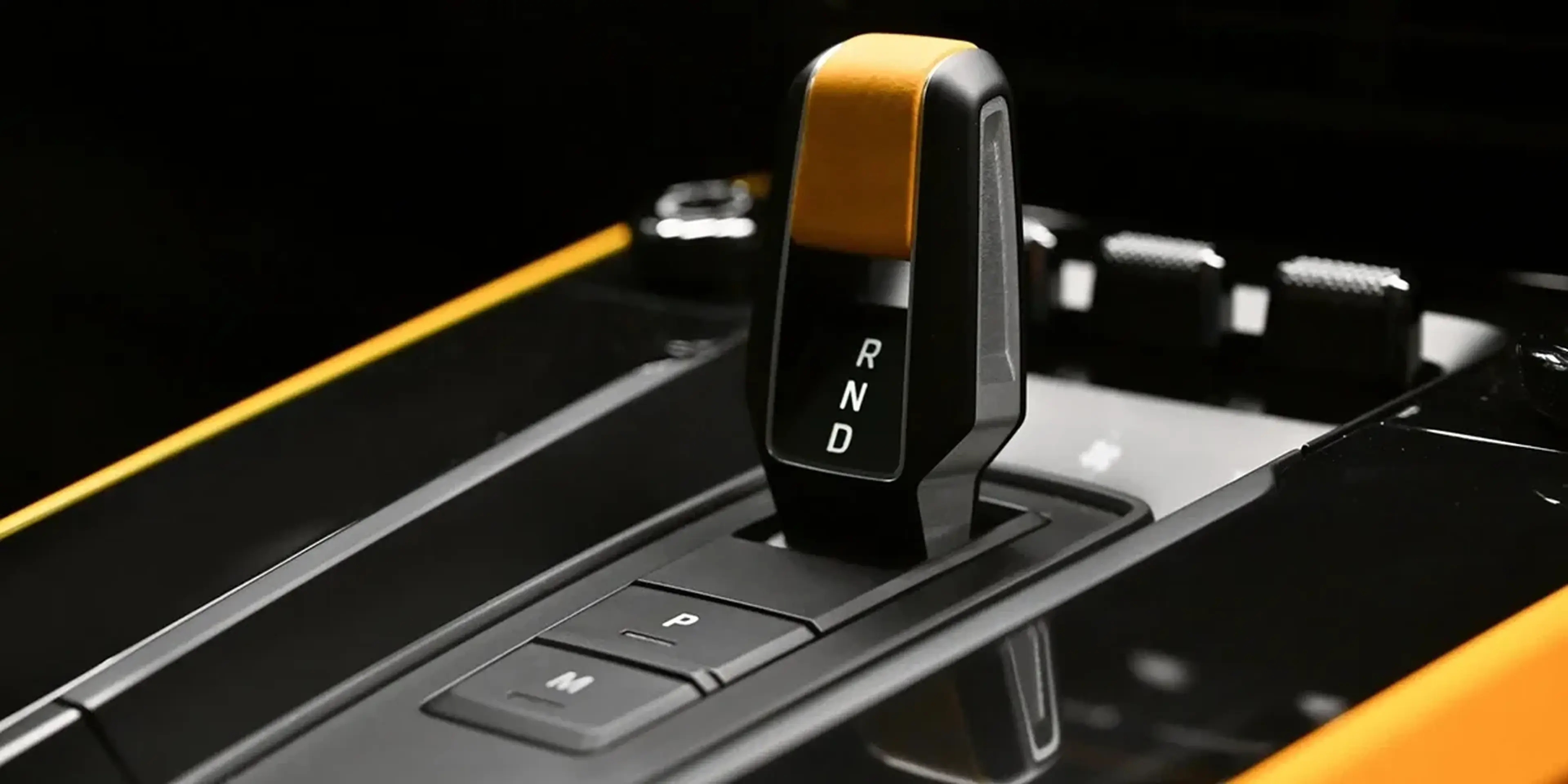 Close-up of Porsche 911 Dakar gear selector with black and yellow interior accents