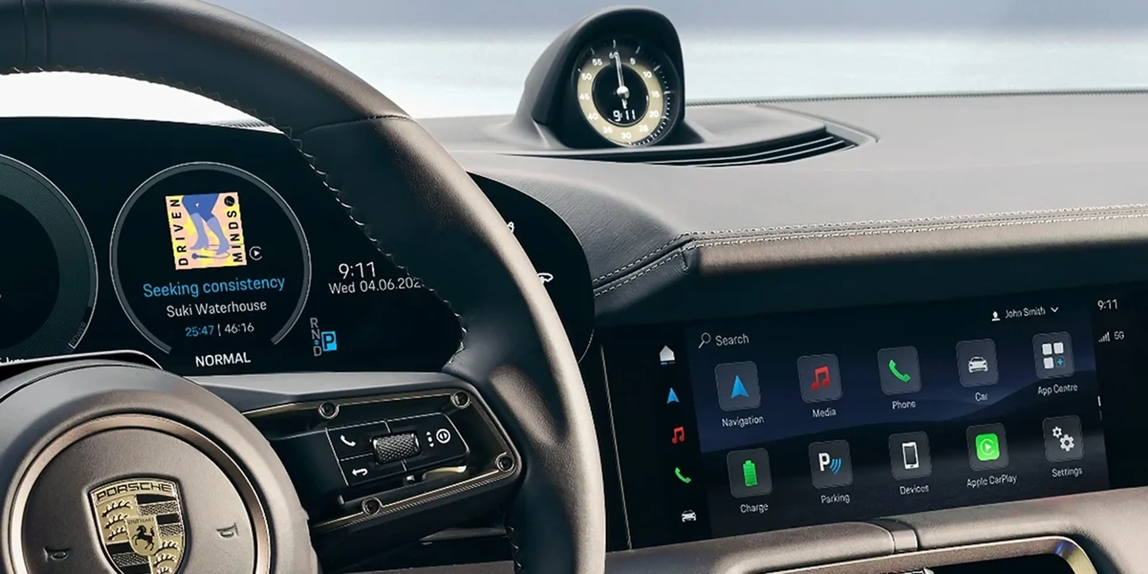 Porsche Taycan interior cockpit showing steering wheel, driver display, and infotainment screen.