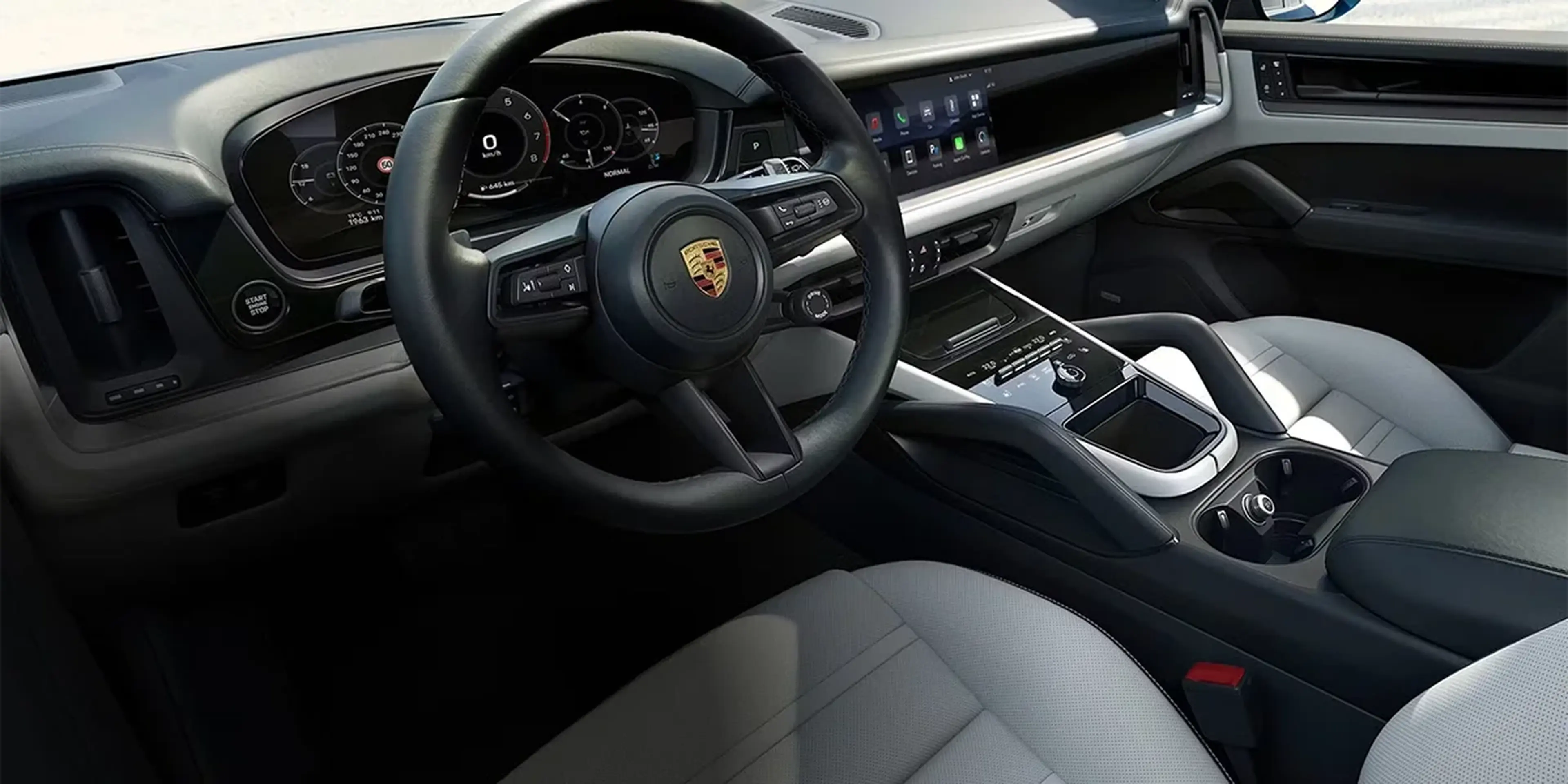 Interior view of 2026 Porsche Cayenne cockpit showing digital displays and controls.