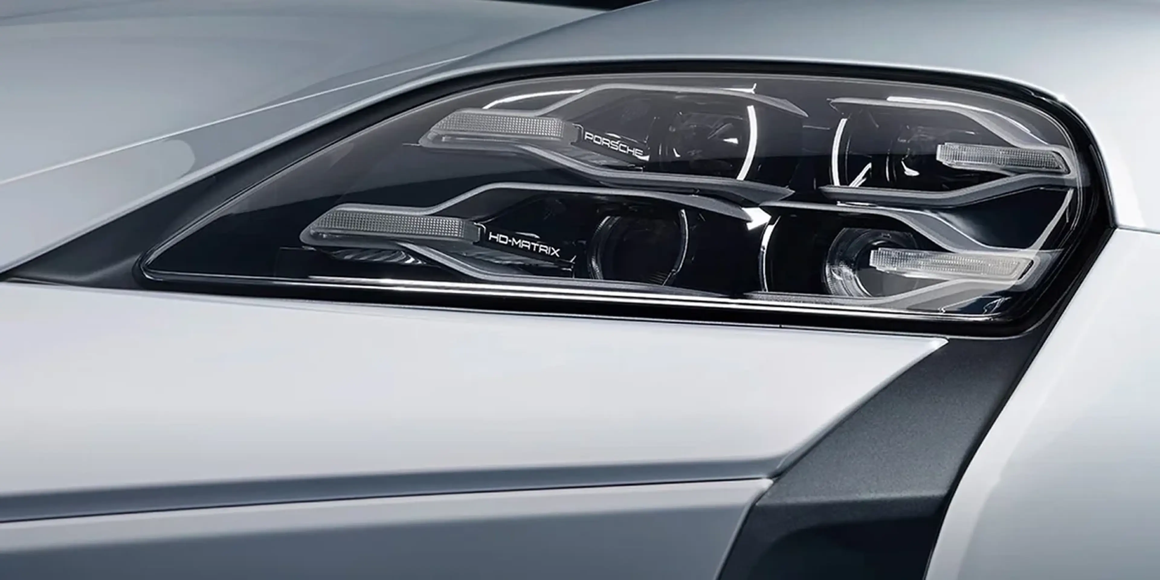 Porsche Taycan headlight close-up showing HD-Matrix LED elements.