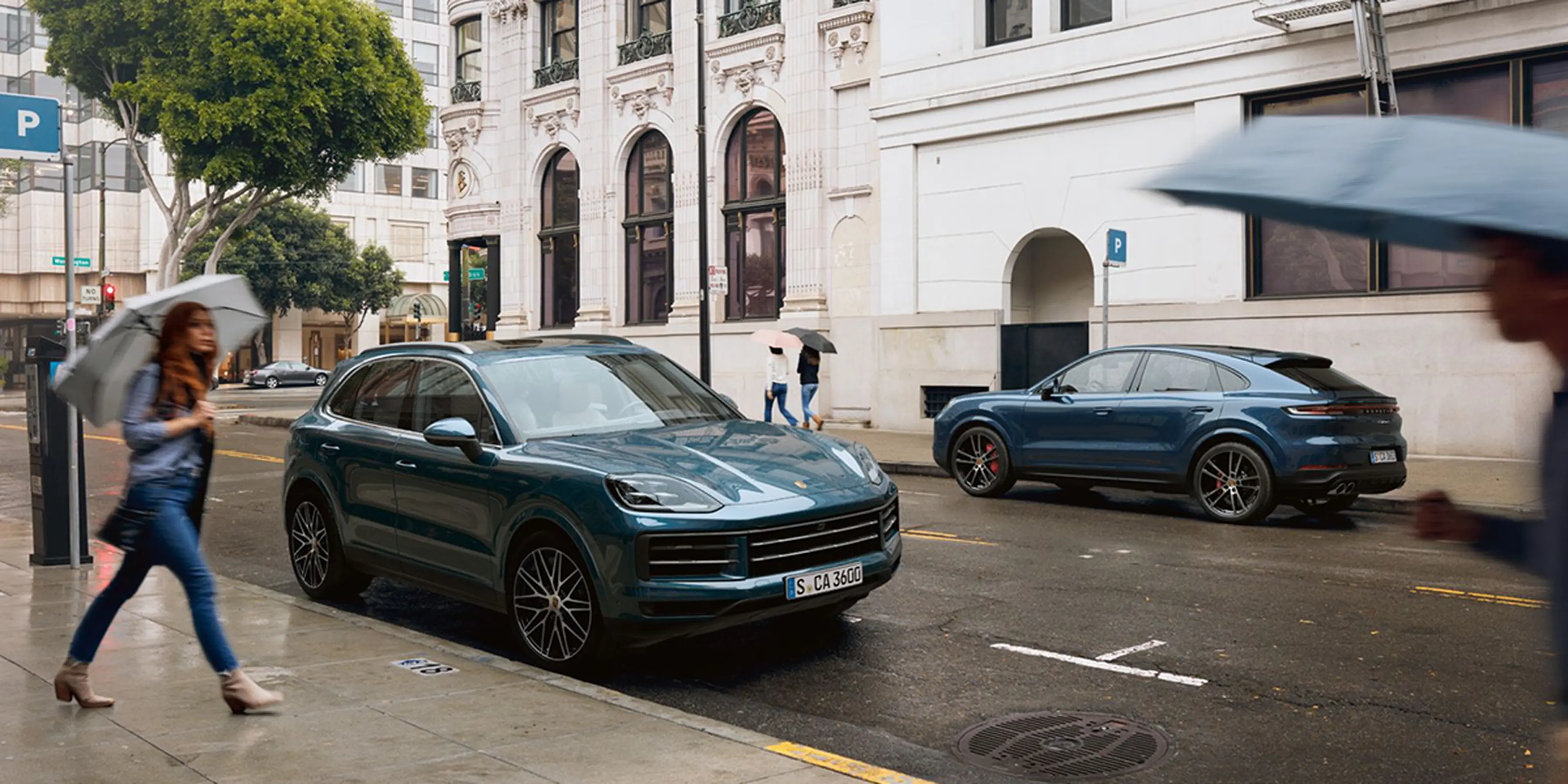 Green 2025 Porsche Cayenne parked on a historic city street