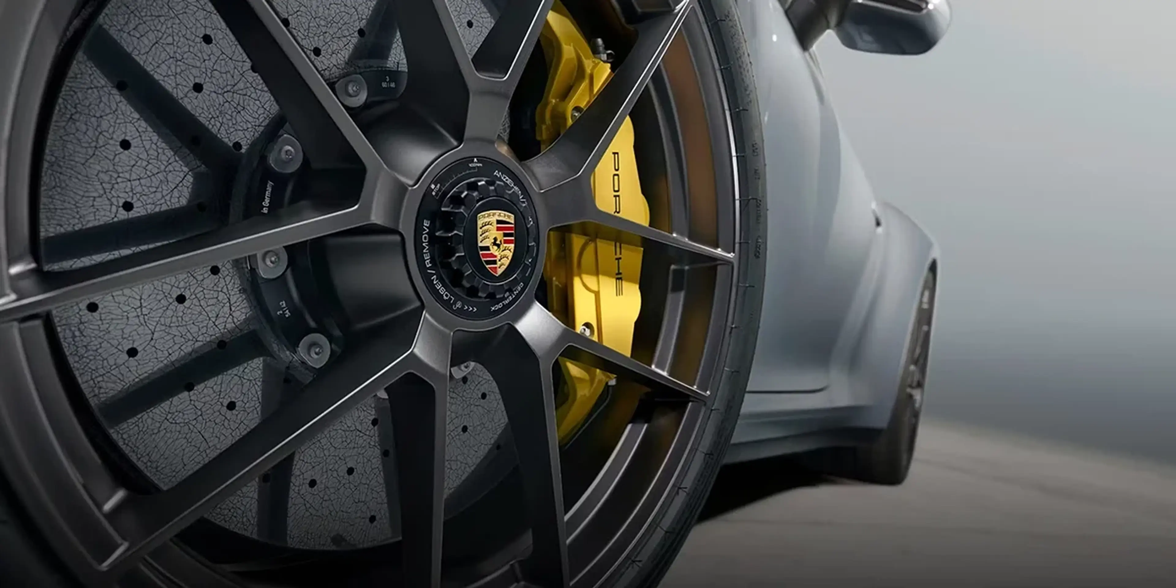 Dynamic driving shot of Porsche 911 Carrera 4S showcasing 3.3-second 0–60 mph acceleration and precision handling.